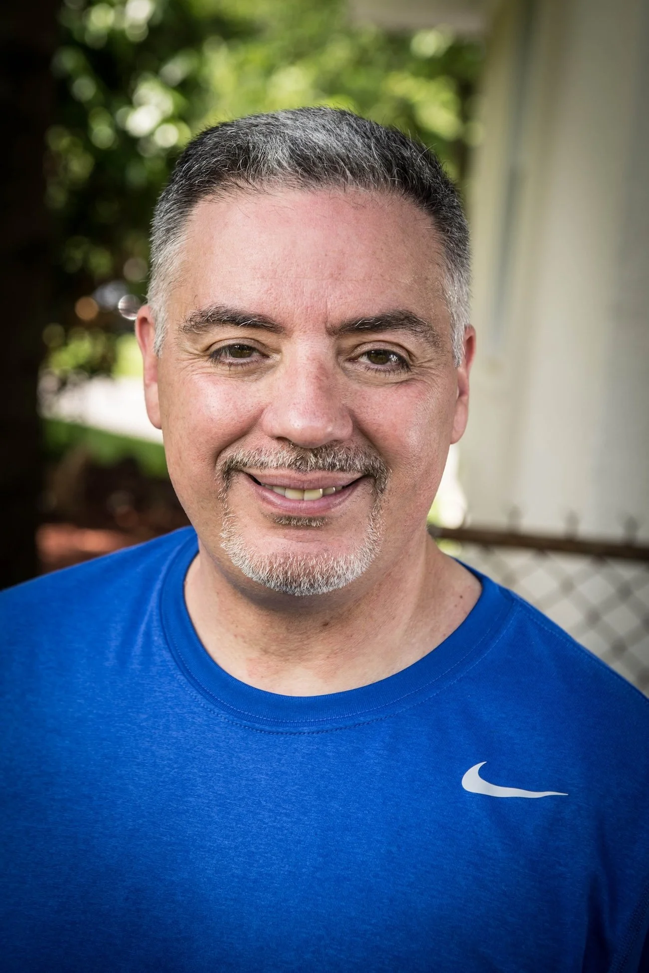 Jimmy Onorato wearing a blue athletic shirt outdoors.