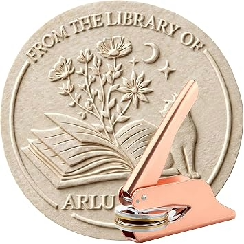 Round beige library embossing stamp emblem with an open book, flowers, crescent moon and star, overlaid by a pink embossing stamp; text reads “FROM THE LIBRARY OF.”