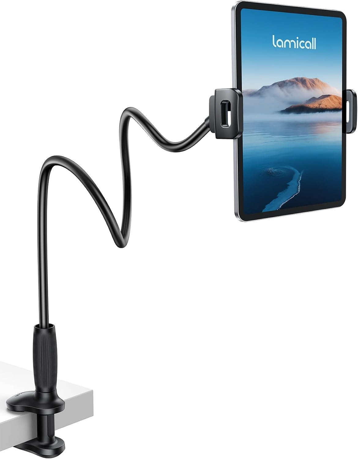 Black flexible gooseneck tablet holder clamped to a desk, supporting a portrait tablet displaying a serene mountain lake scene.