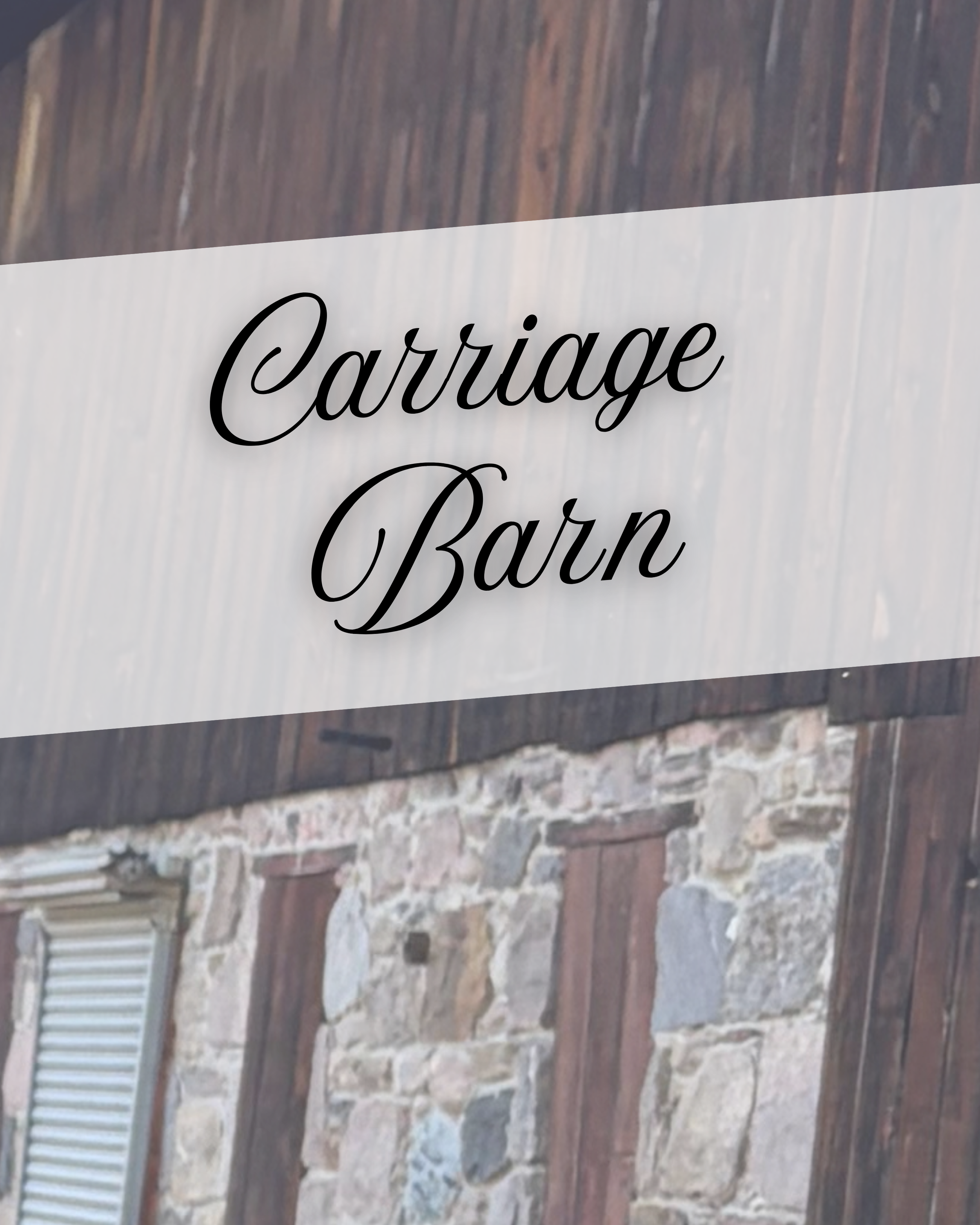 A sign on a brick and stone wall reads 'Carriage Barn' in black cursive font.