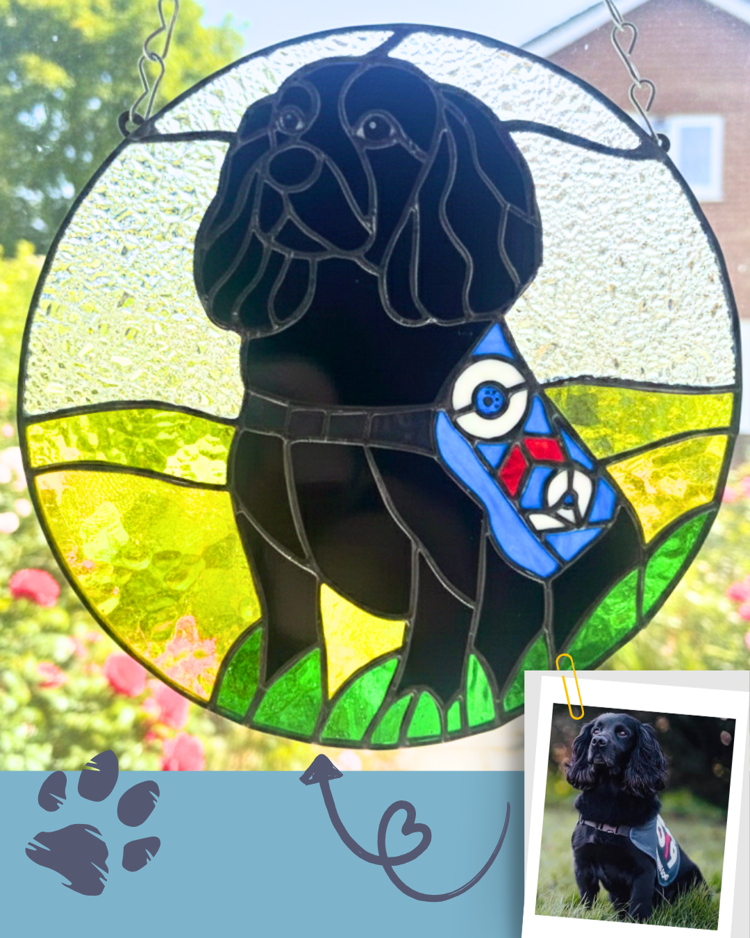 Circular stained glass portrait of a black dog hanging in a window, with sunlight shining through green and yellow glass.