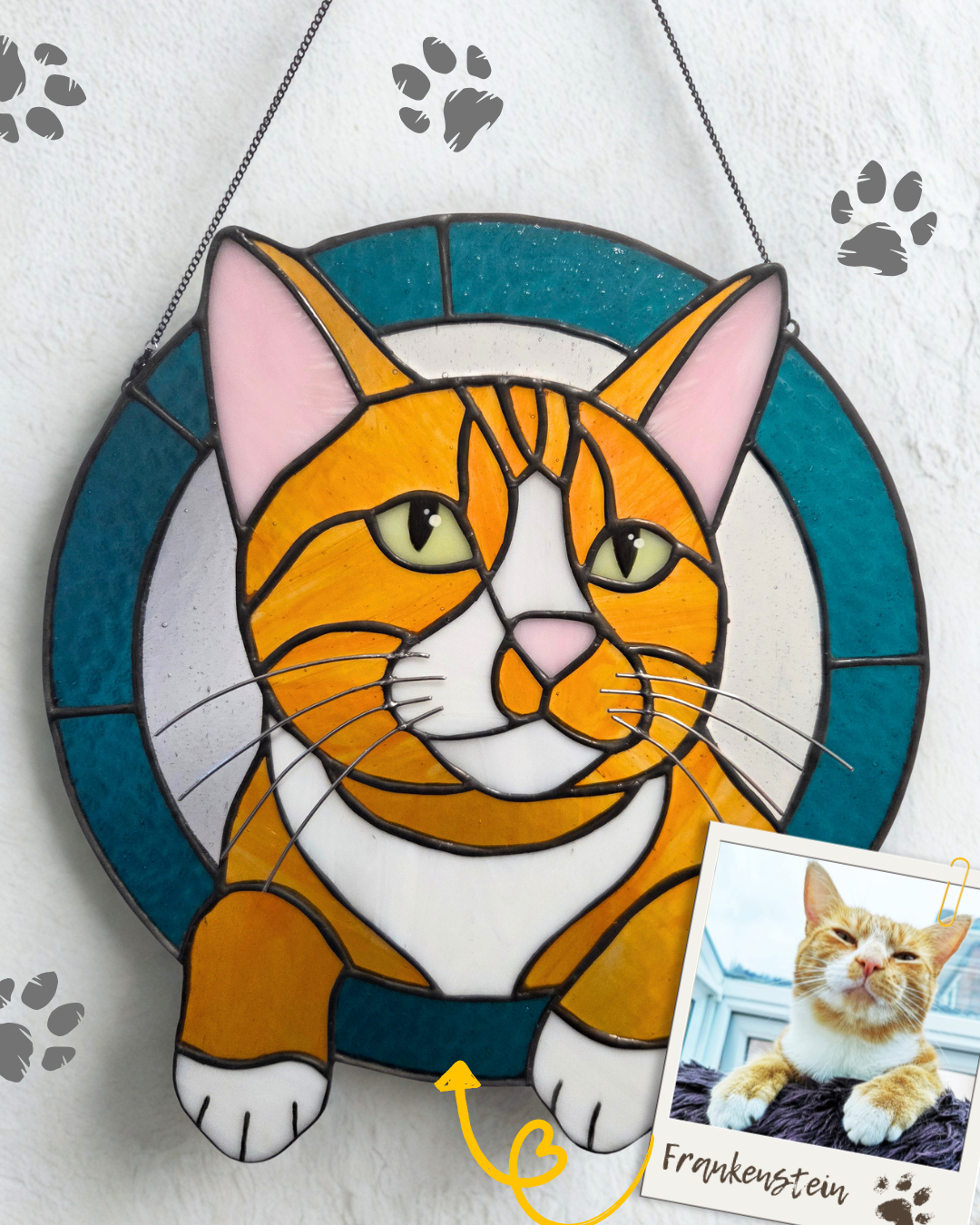 
Ginger and white cat stained glass portrait with a turquoise circular border and front paws extending below the frame.