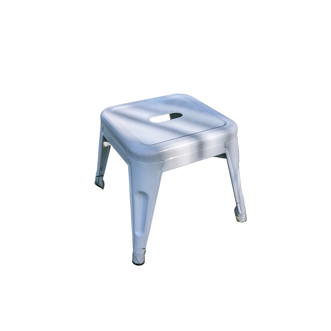 A white metal stool with a square seat and a hole in the center, four legs, and a simple design.