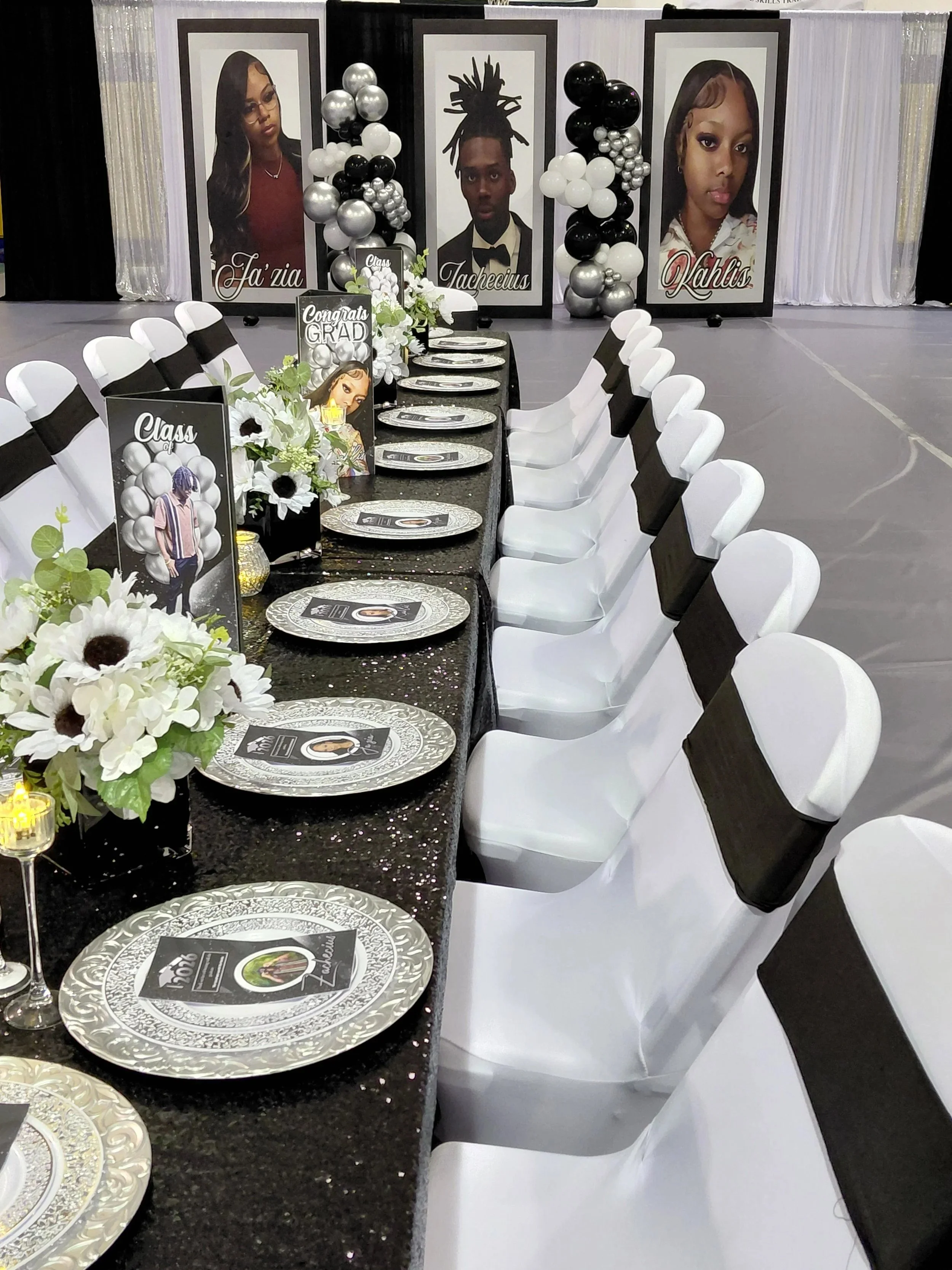 A sophisticated black, white, and silver graduation celebration for three, featuring bold custom photo boards that anchor the entire design.