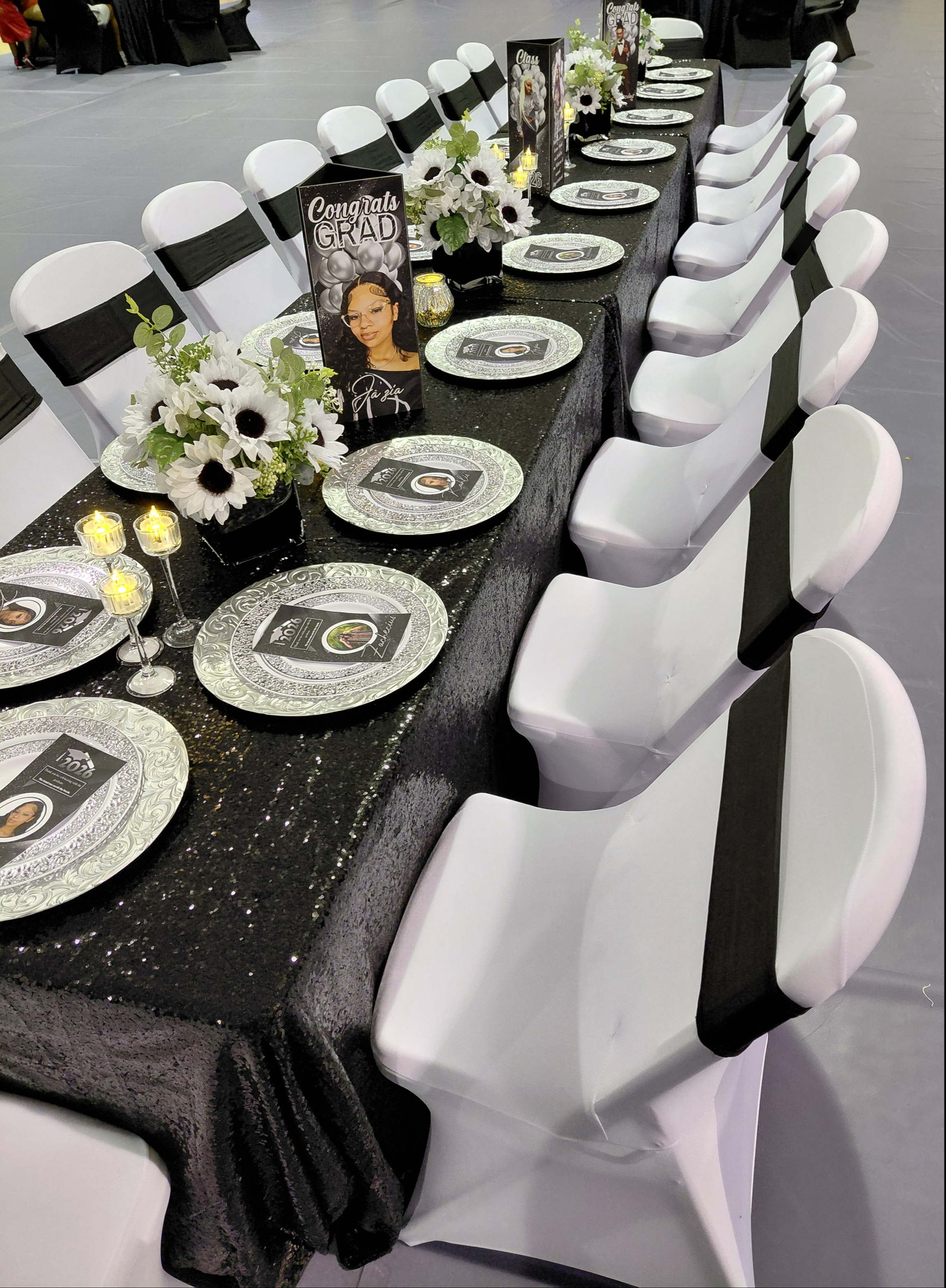 A sophisticated black, white, and silver graduation celebration for three, featuring bold custom photo boards that anchor the entire design.