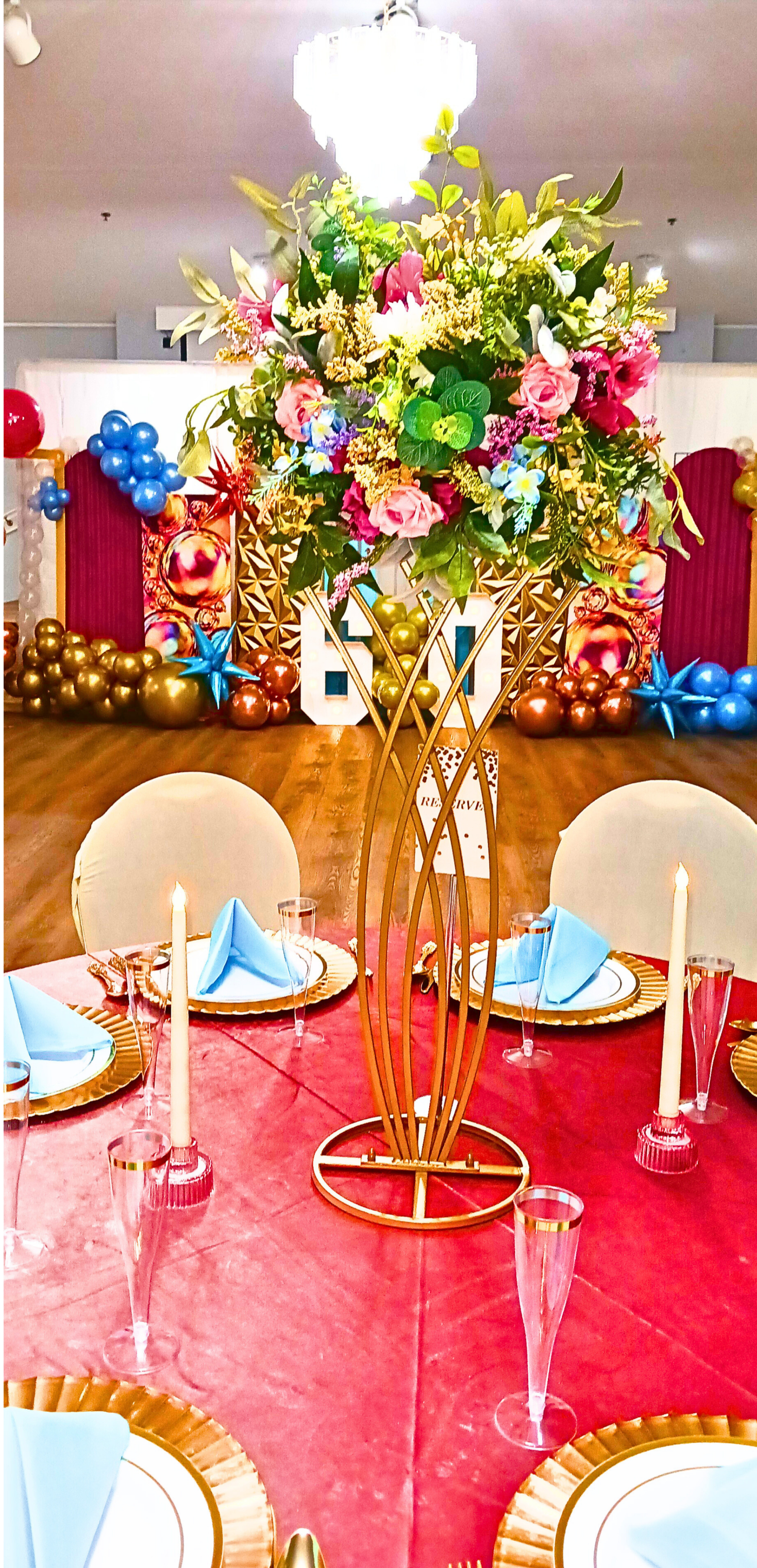 A vibrant 60th birthday celebration featuring a rich rainbow color palette, velvet tablecloths, lush rainbow florals, and touches of gold for a timeless, joyful look.  A fabulous milestone beautifully honored.