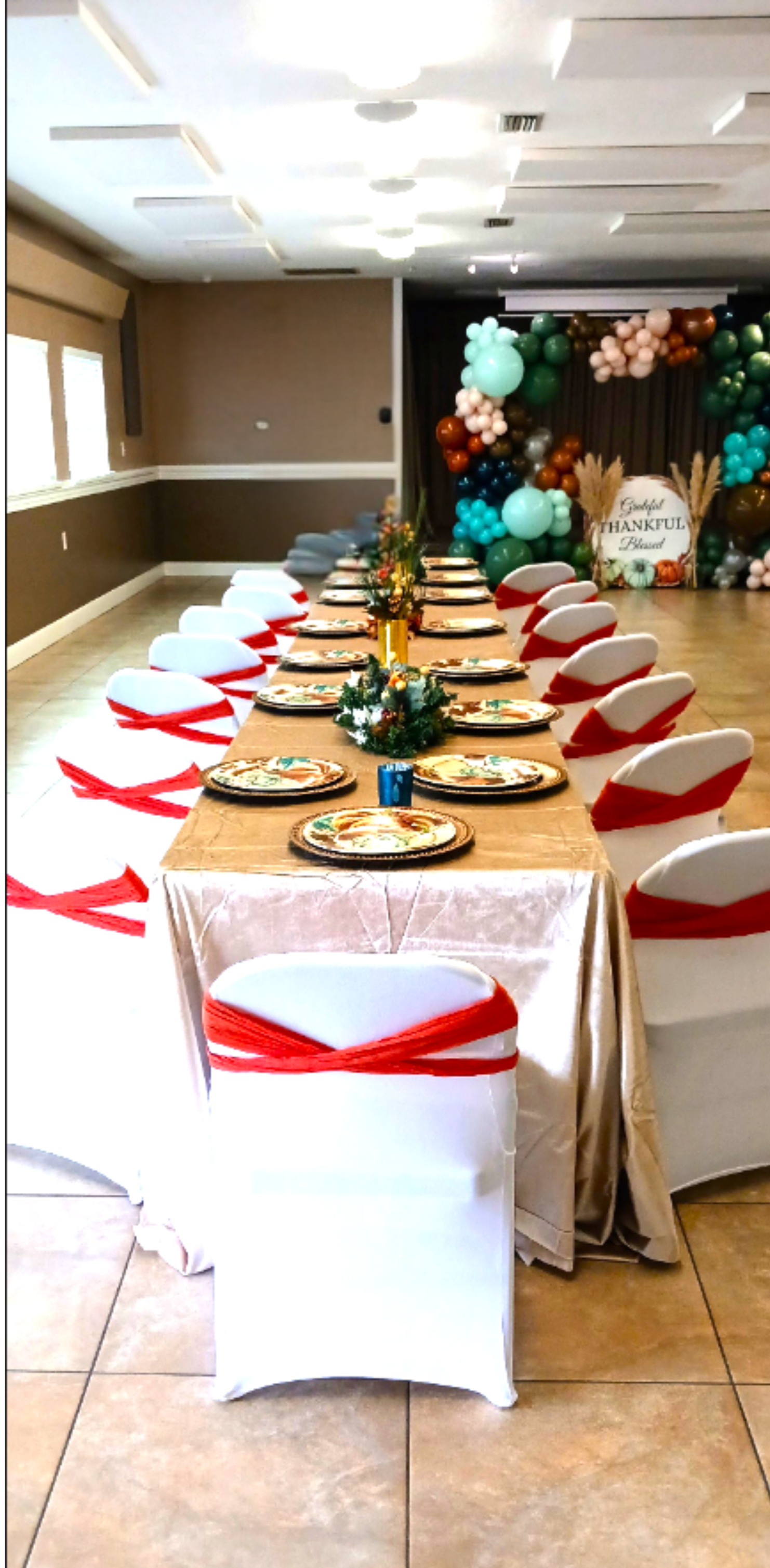 A family style Thanksgiving dinner featuring rich fall tones and a festive backdrop that enhances the celebration.