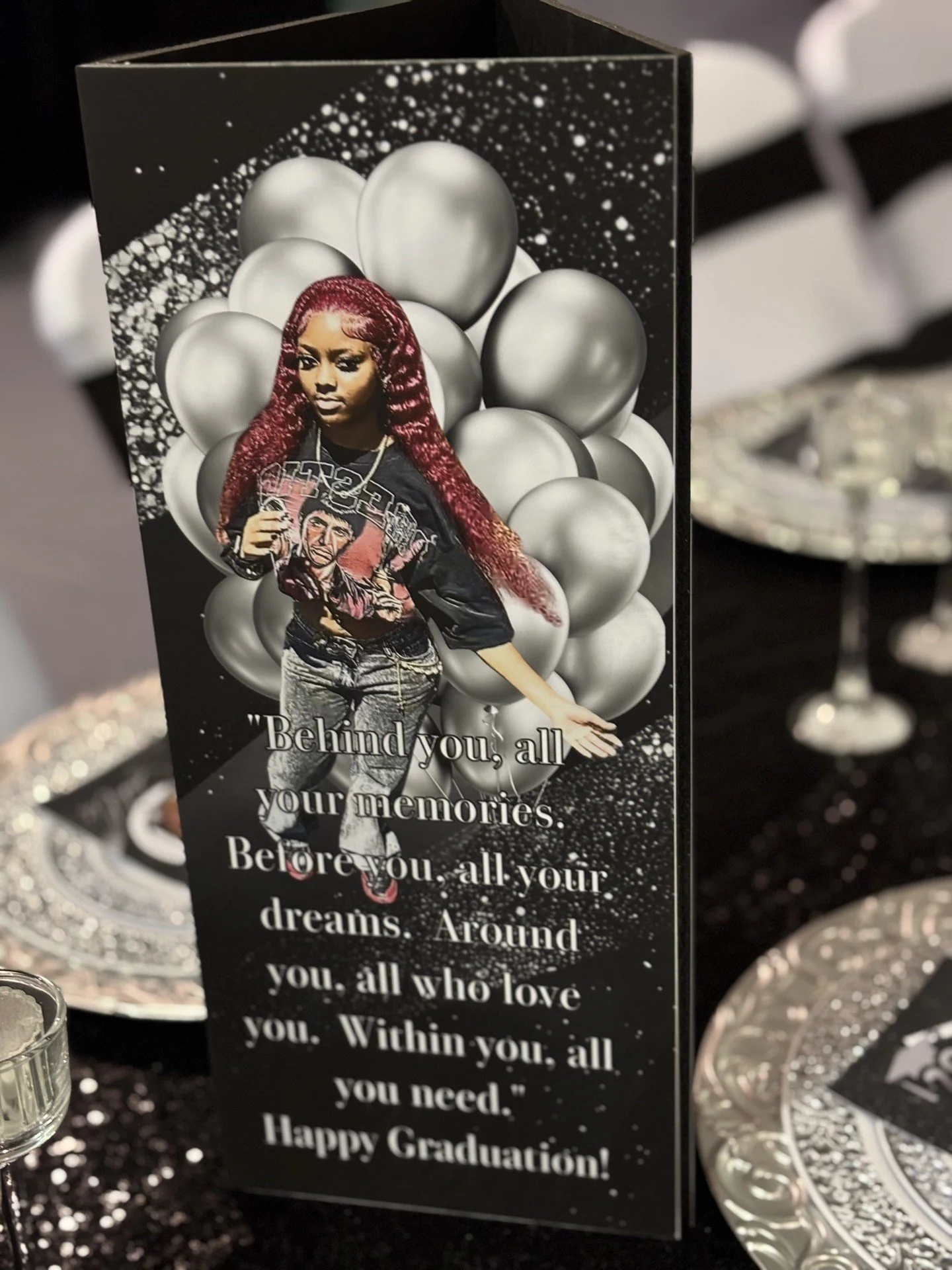 A sophisticated black, white, and silver graduation celebration for three, featuring bold custom photo boards that anchor the entire design.