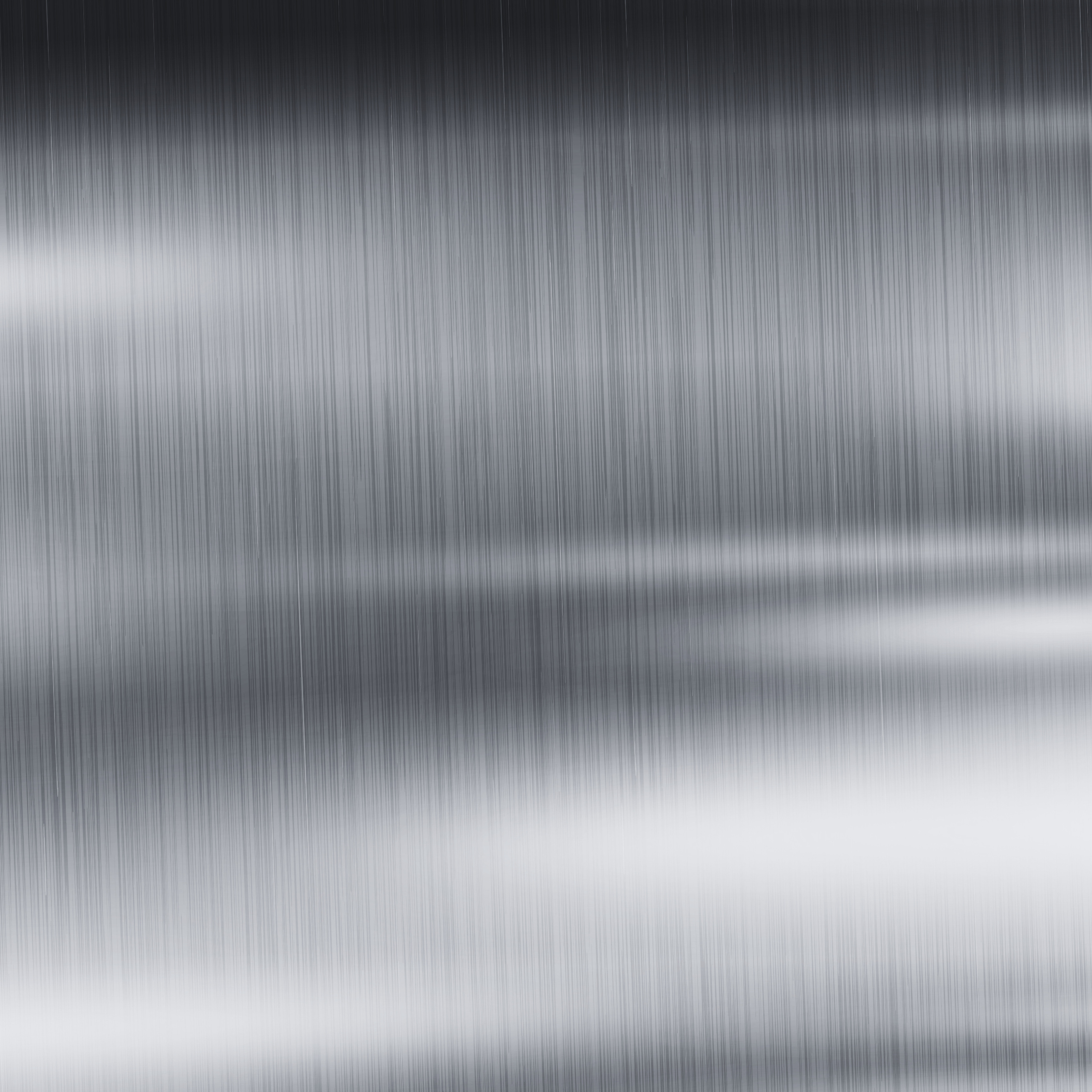 A close-up of a brushed metal surface with vertical lines and a gradient from dark to light.