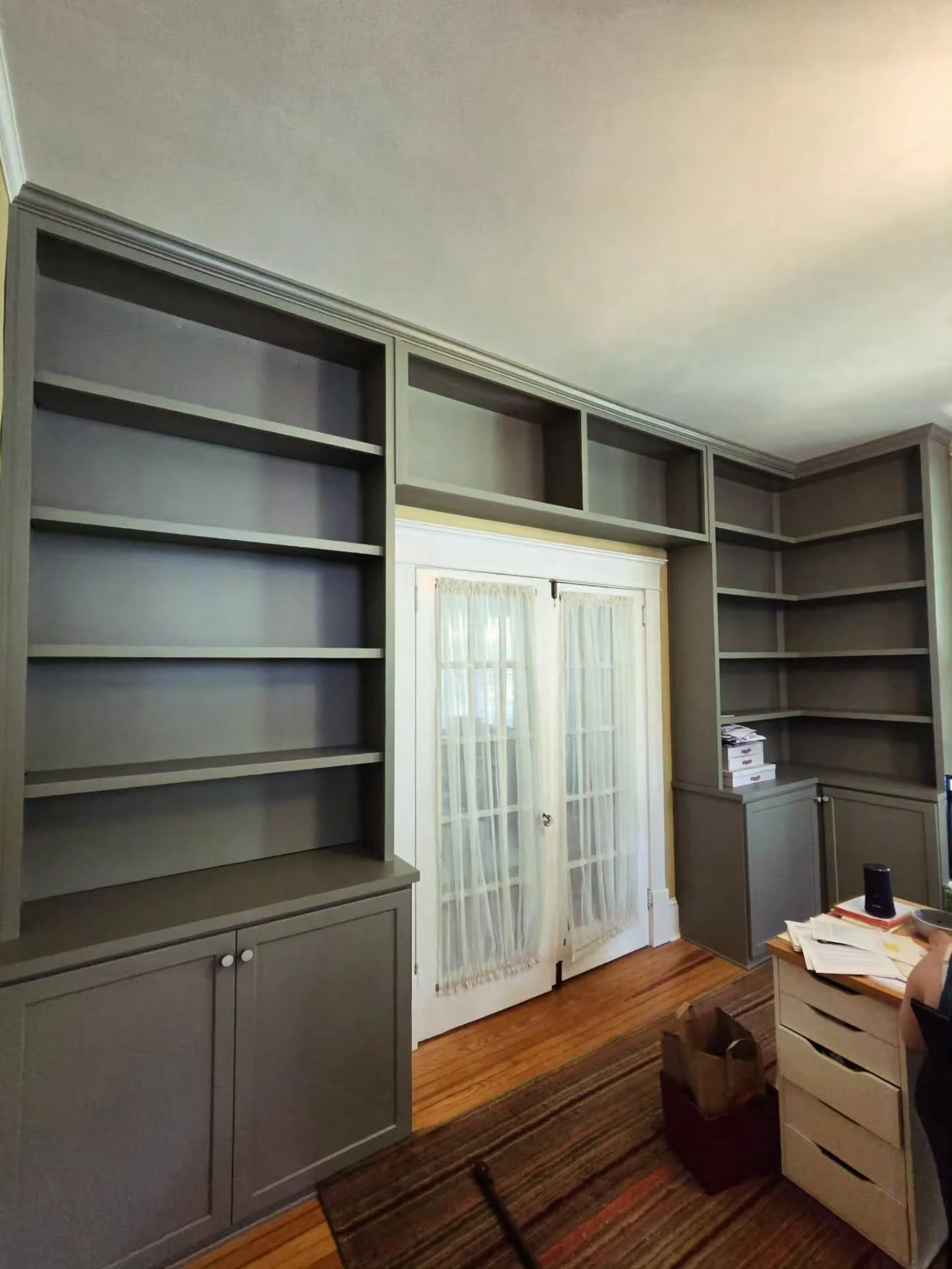 Office - Wraparound cabinets with a continuous corner and window bench. Hallway sideboard with Sapele top. Color - BM Rolling Hills.
