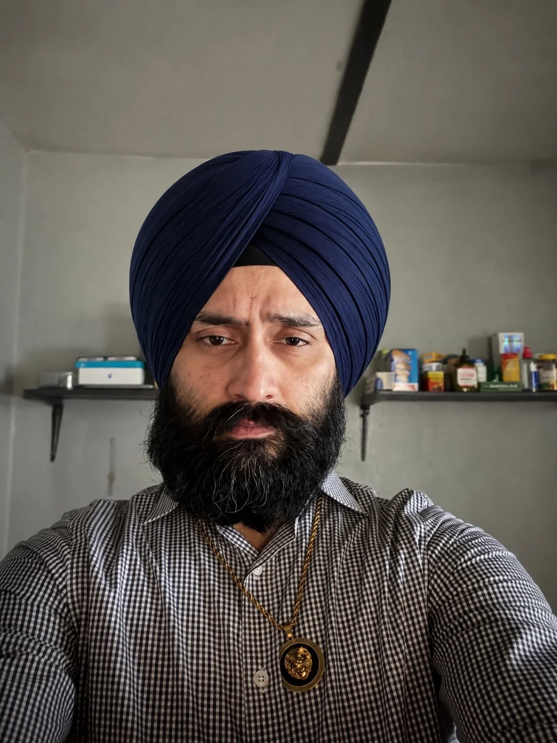 Formal portrait of ProfessorDrSufi wearing a navy blue turban.