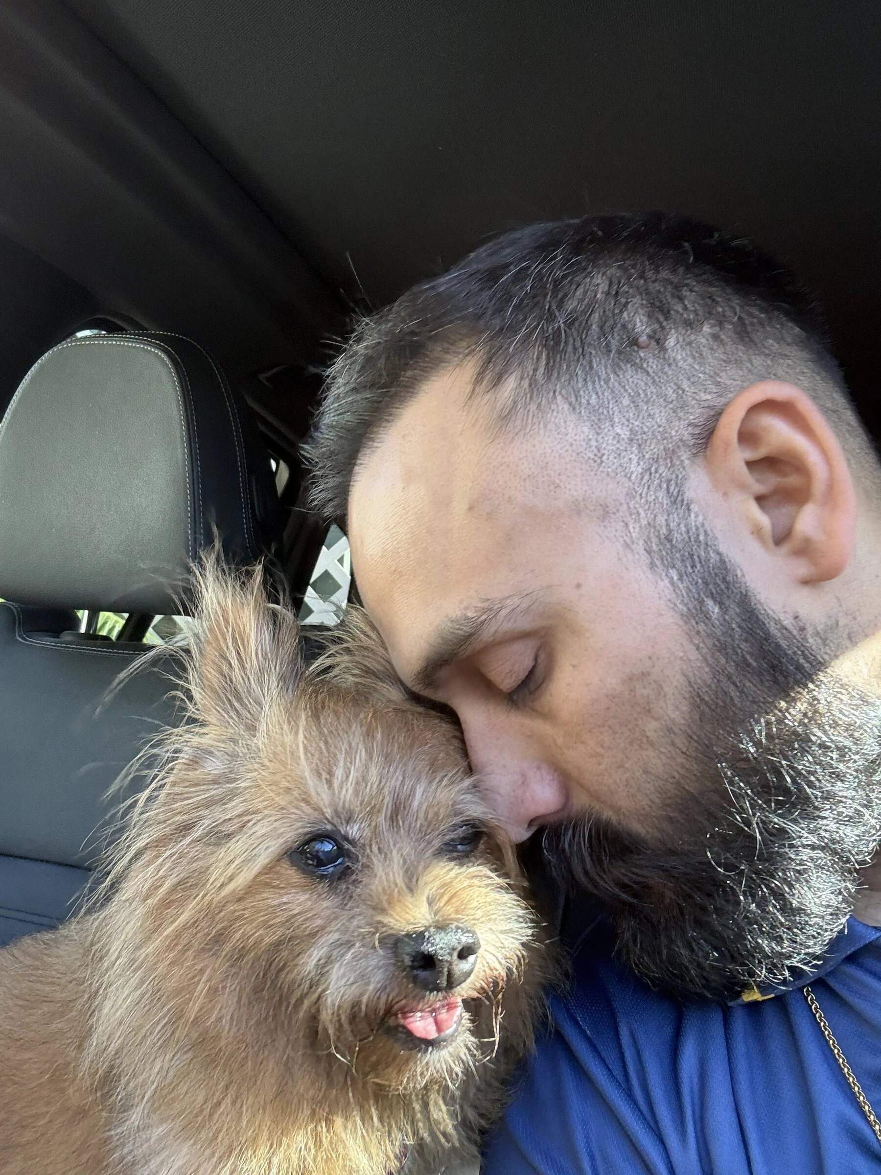 Lifestyle portrait of ProfessorDrSufi sharing an affectionate moment with his dog.