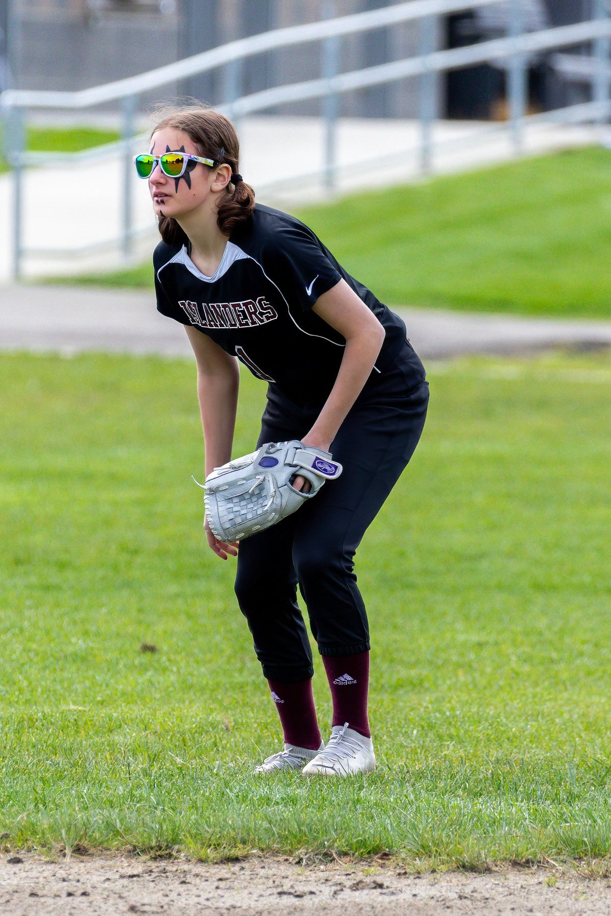 Islander softball player readies her glove on the field.