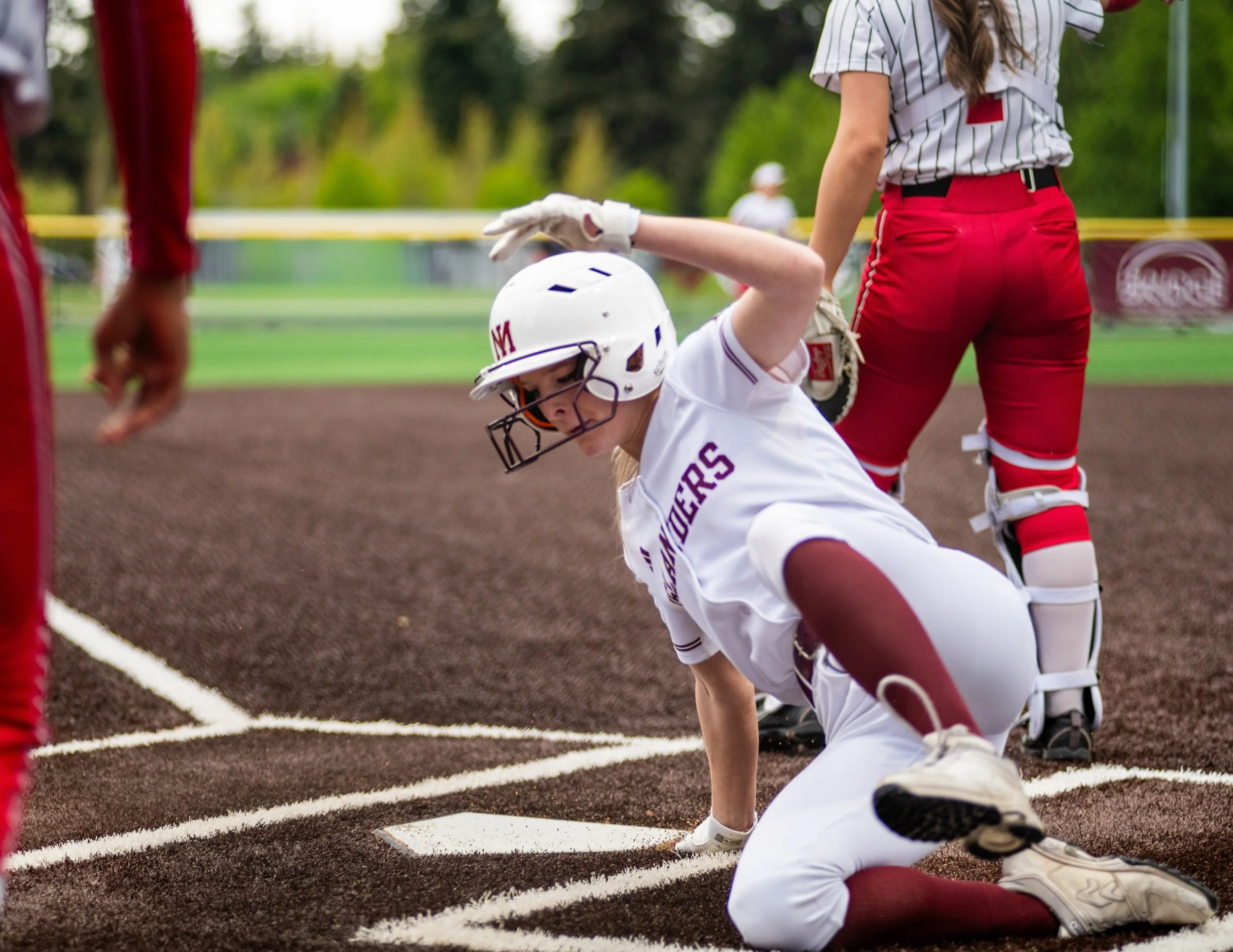 Mercer Island softball runner slides into home plate.