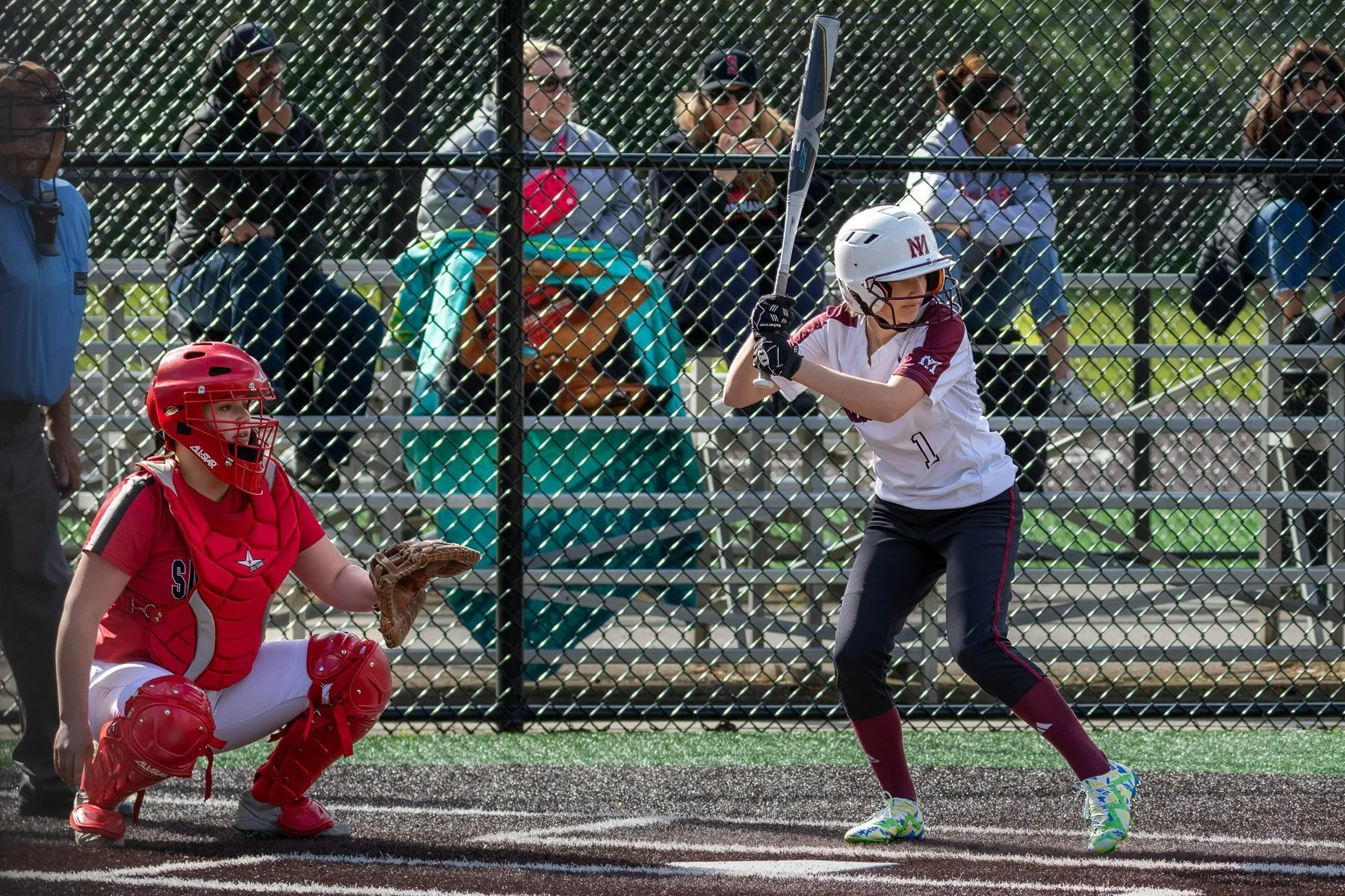 Mercer Island softball batter waits for a pitch beside the catcher.