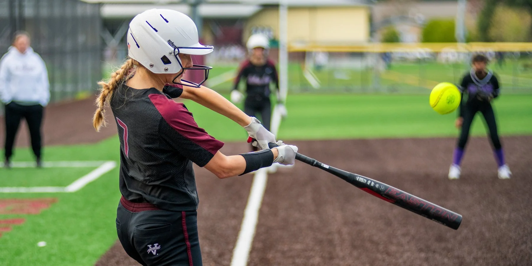 Mercer Island softball batter makes contact with the ball.