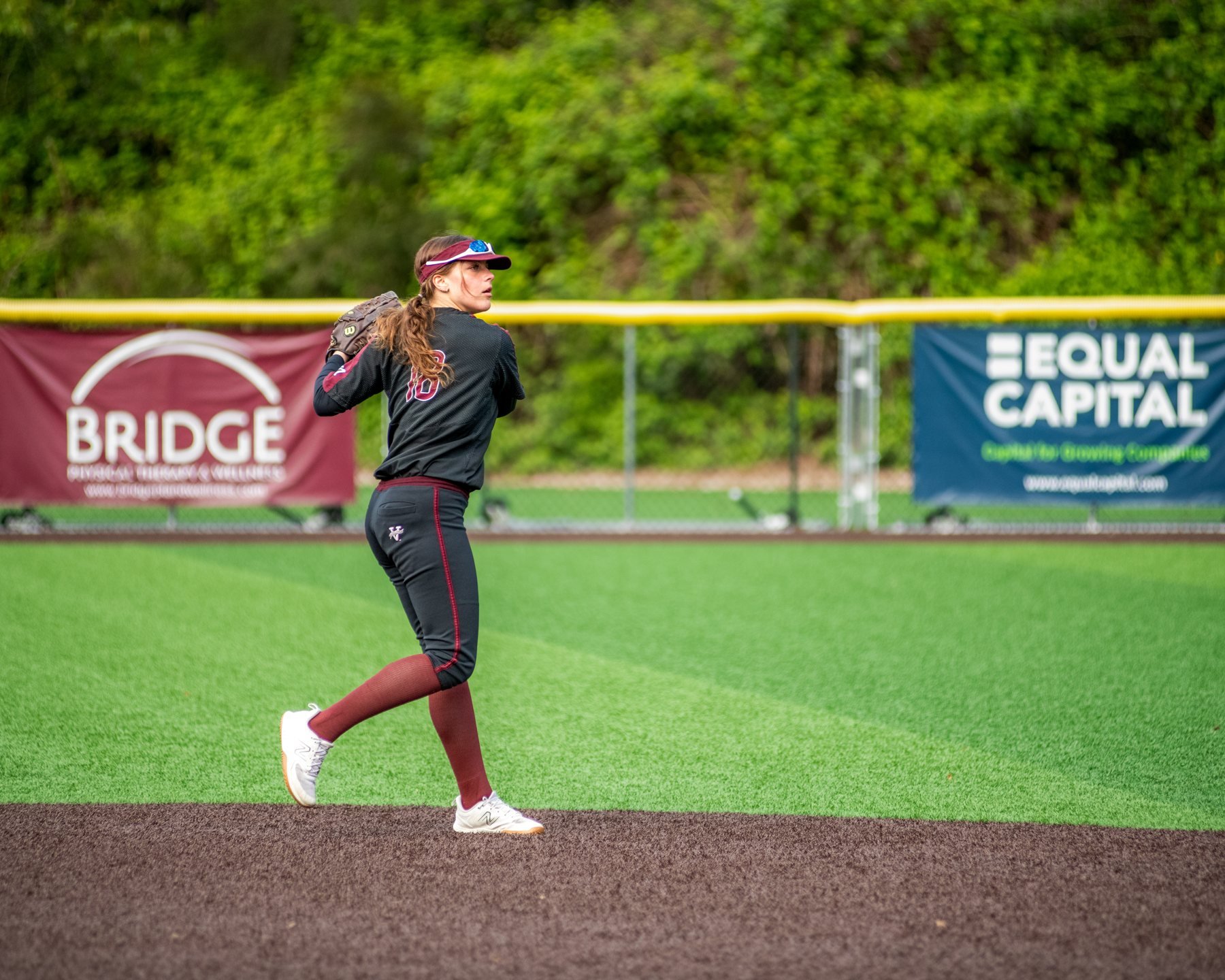 Islander softball player throws across the infield.