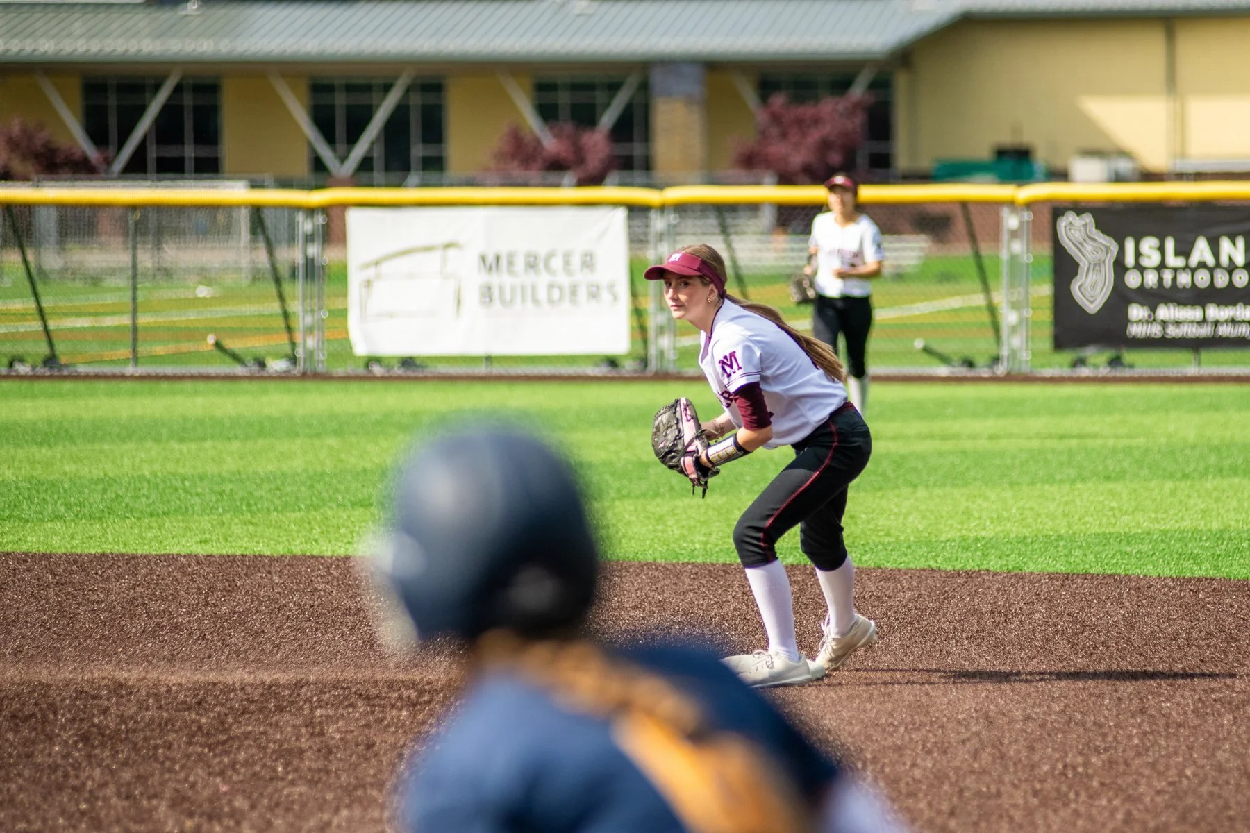 MIHS softball infielder prepares to field the ball.