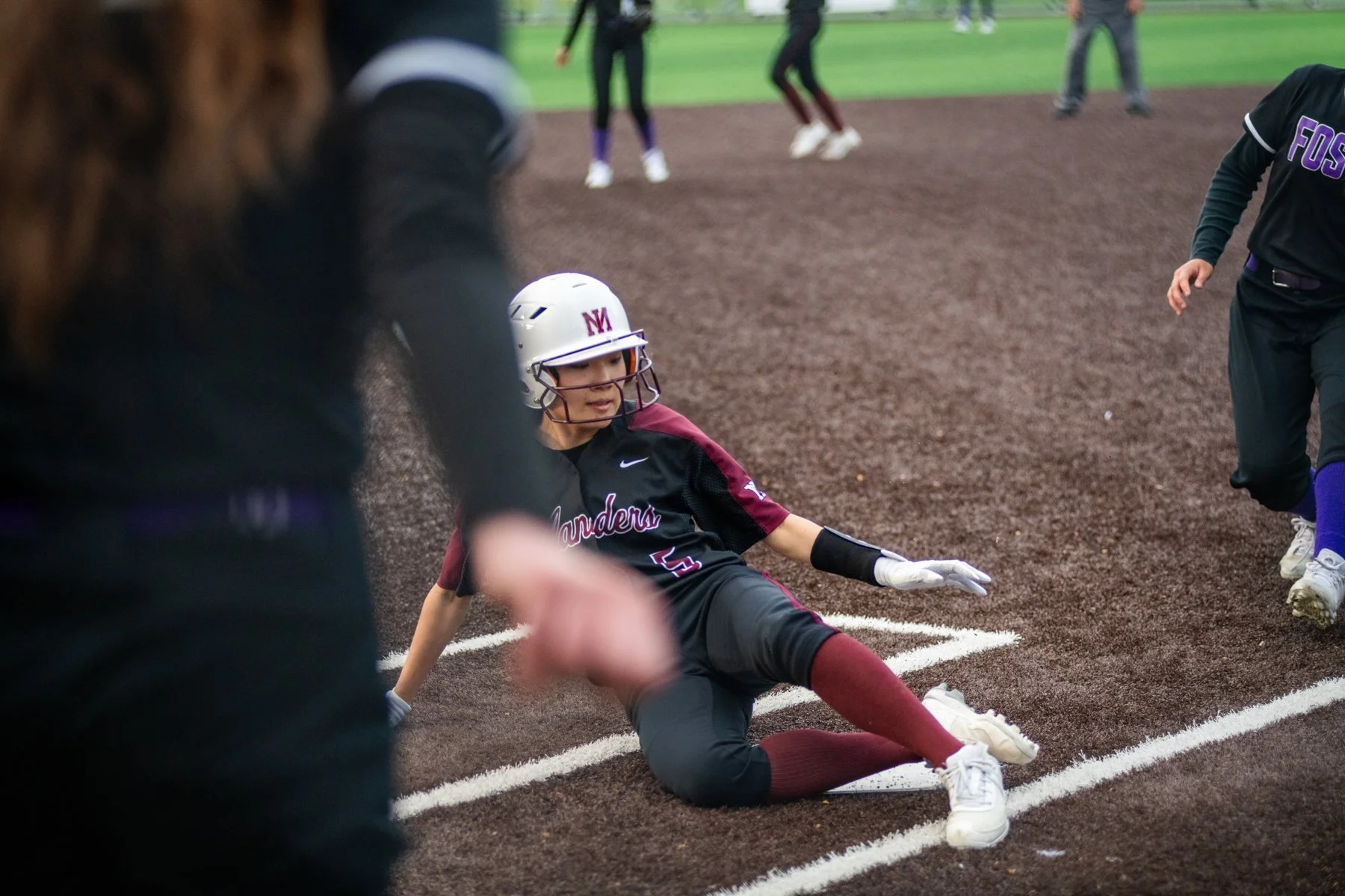 Islander softball runner slides into home plate.