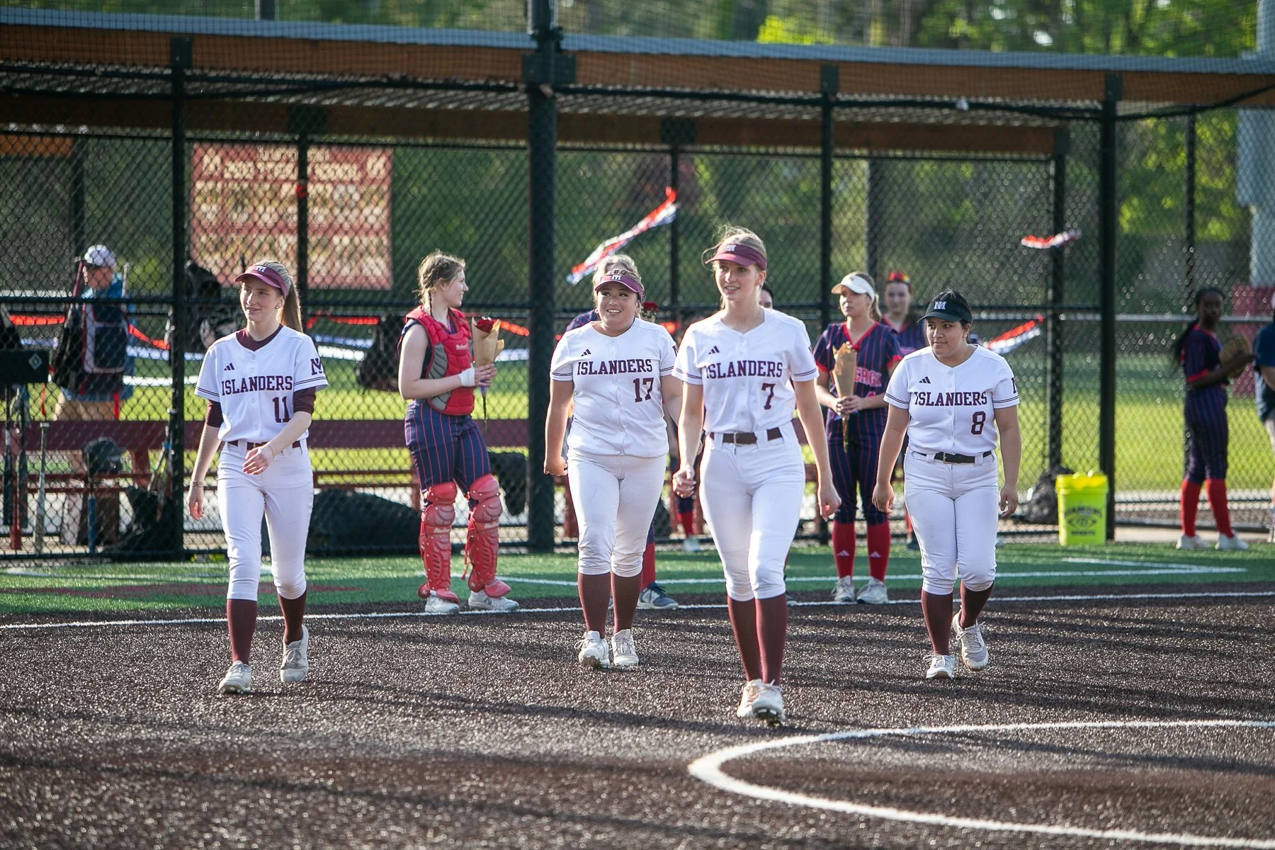 MIHS softball players walk together on the field.