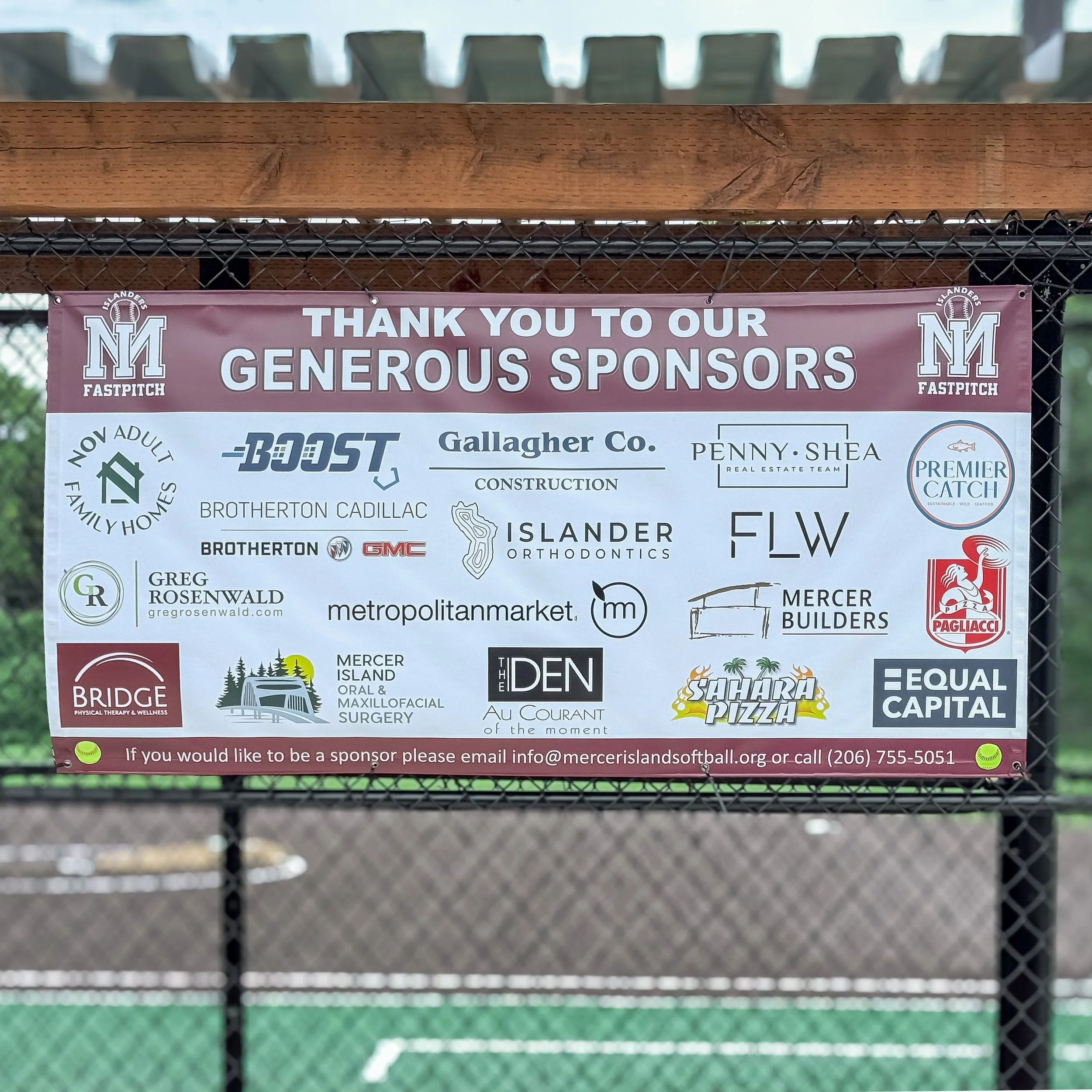 Mercer Island softball sponsor recognition banner displayed at the field.