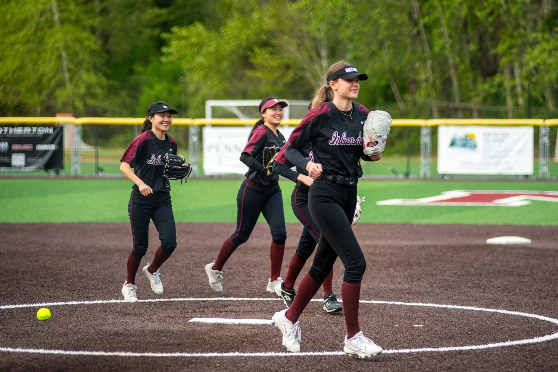Islander softball players jog across the infield.