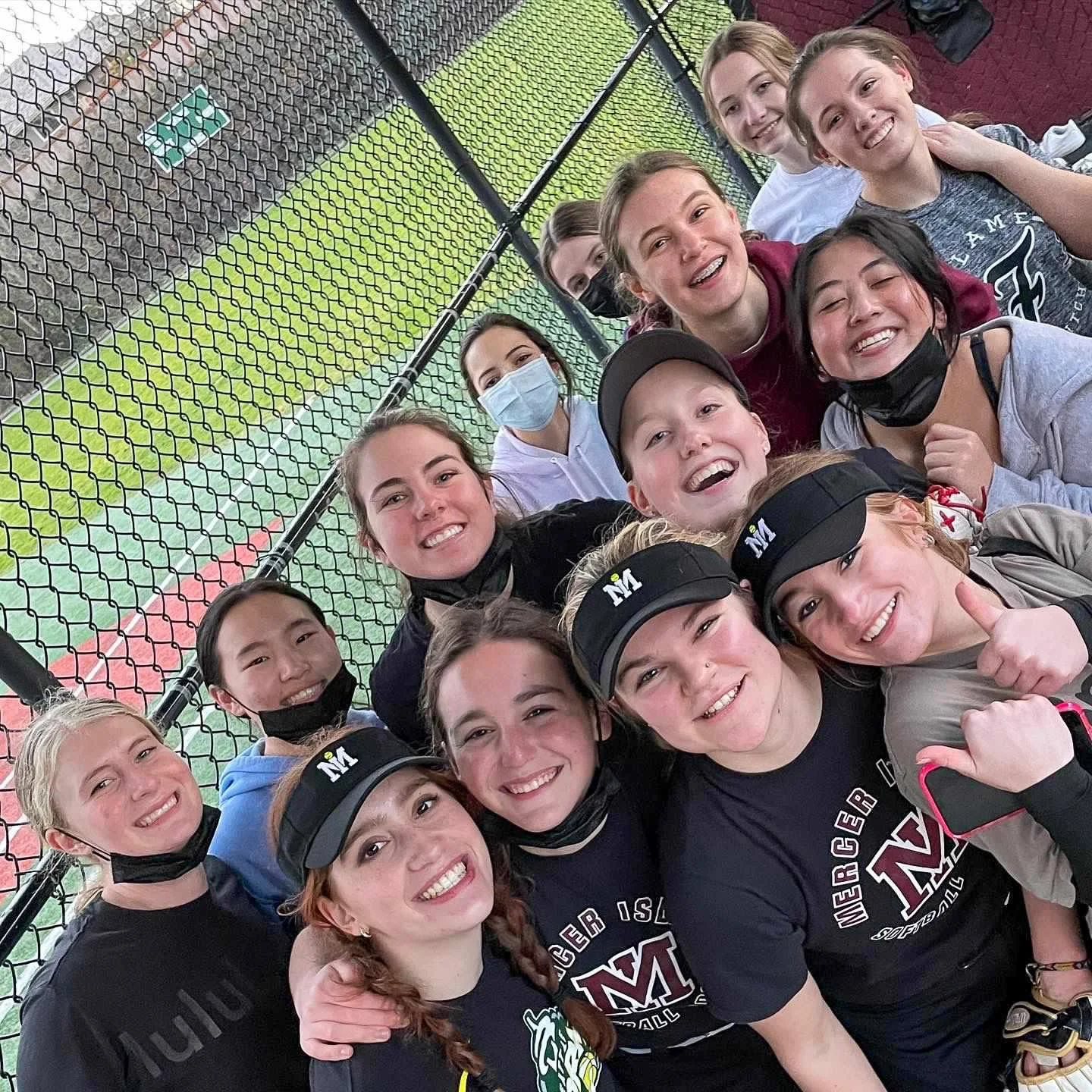 MIHS softball teammates pose together for a dugout selfie.