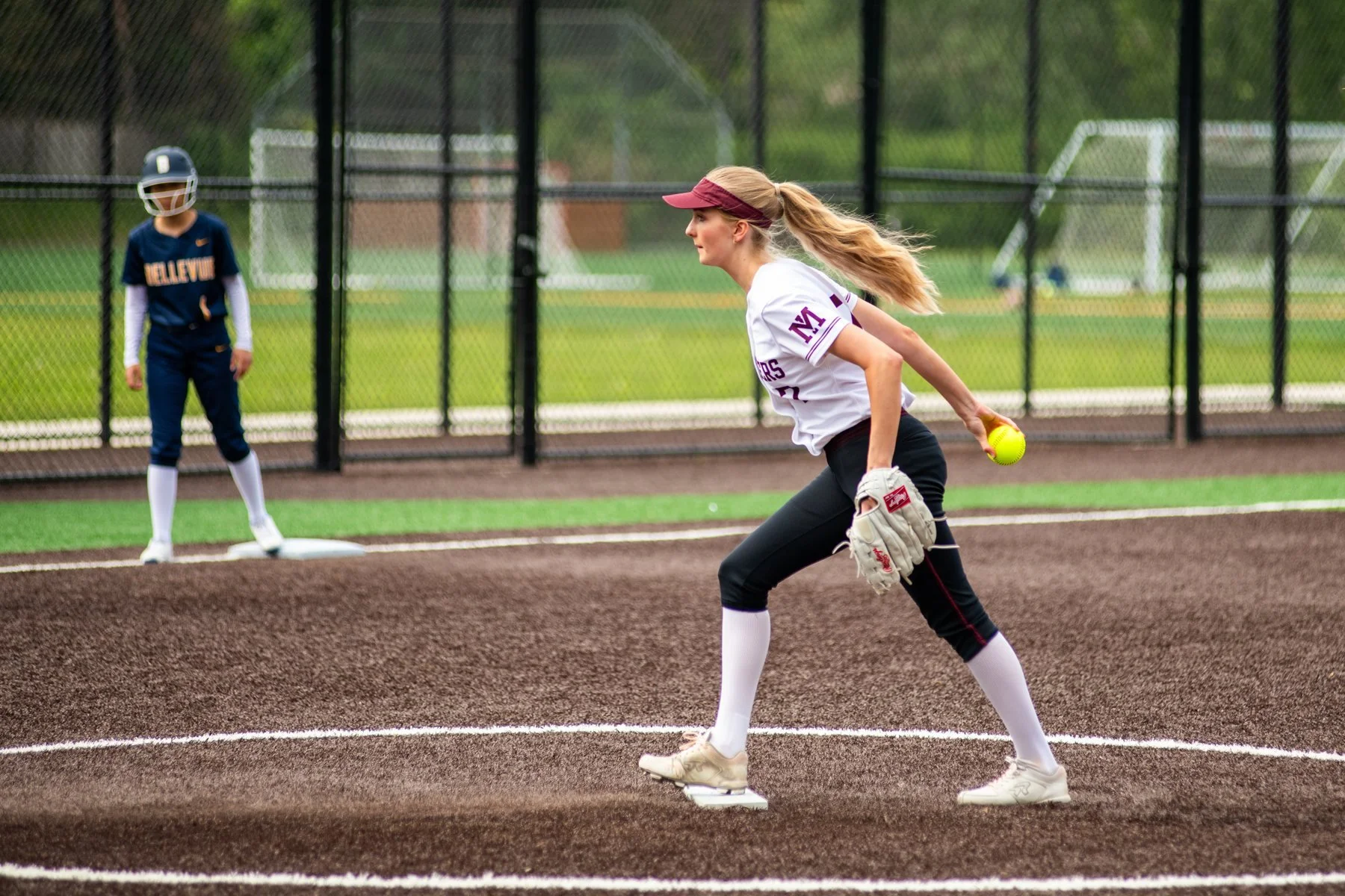 Mercer Island softball pitcher delivers an underhand pitch.