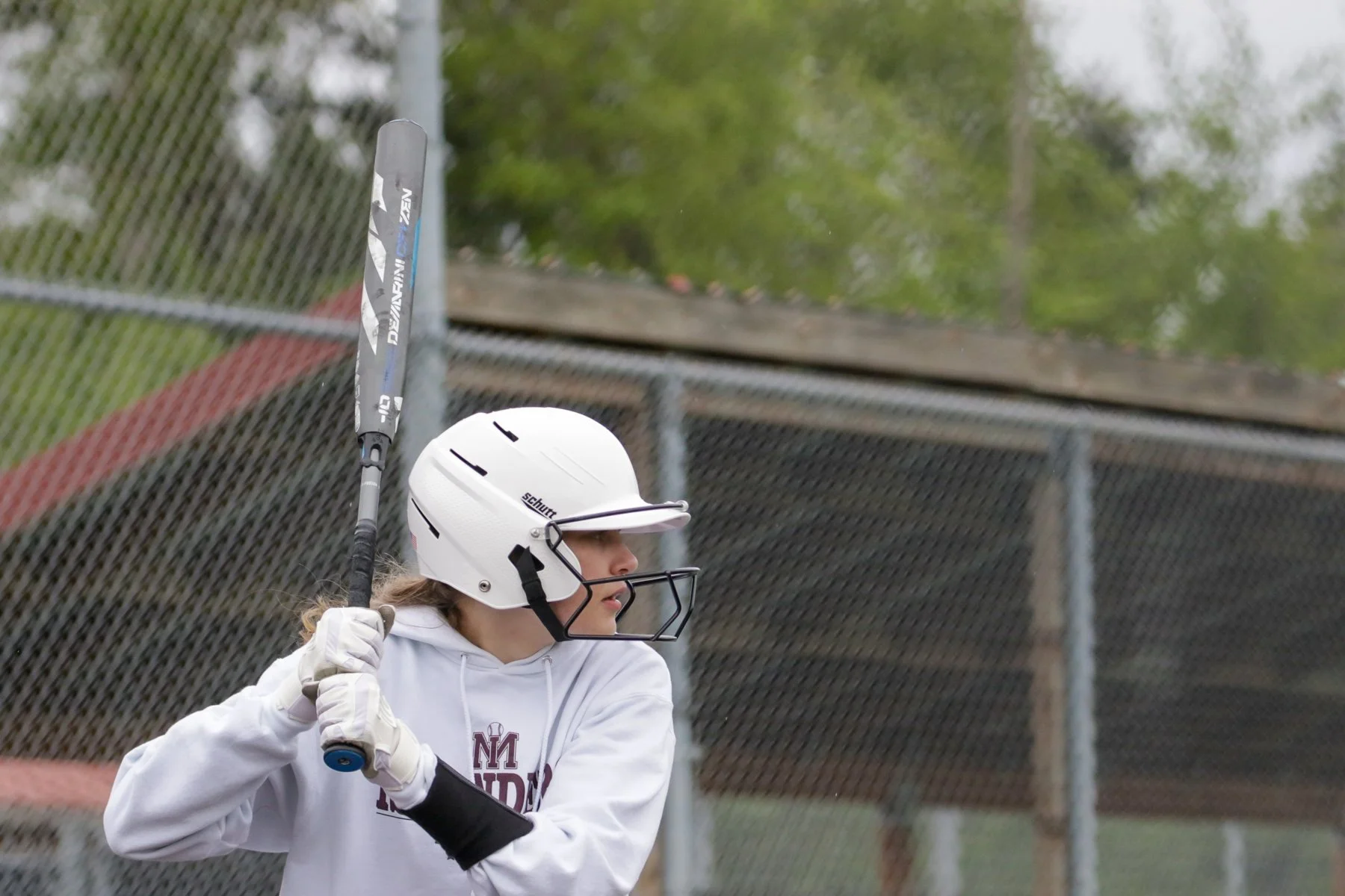 Helmeted Islander softball batter prepares to swing.