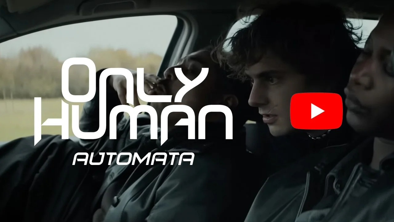 Thumbnail of a still from the music video for the song "Automata". It depicts 2 young men and a woman from the music video sitting in a car. The ONLY HUMAN logo appears on top with the subtitle "Automata" as well as a YouTube play icon.