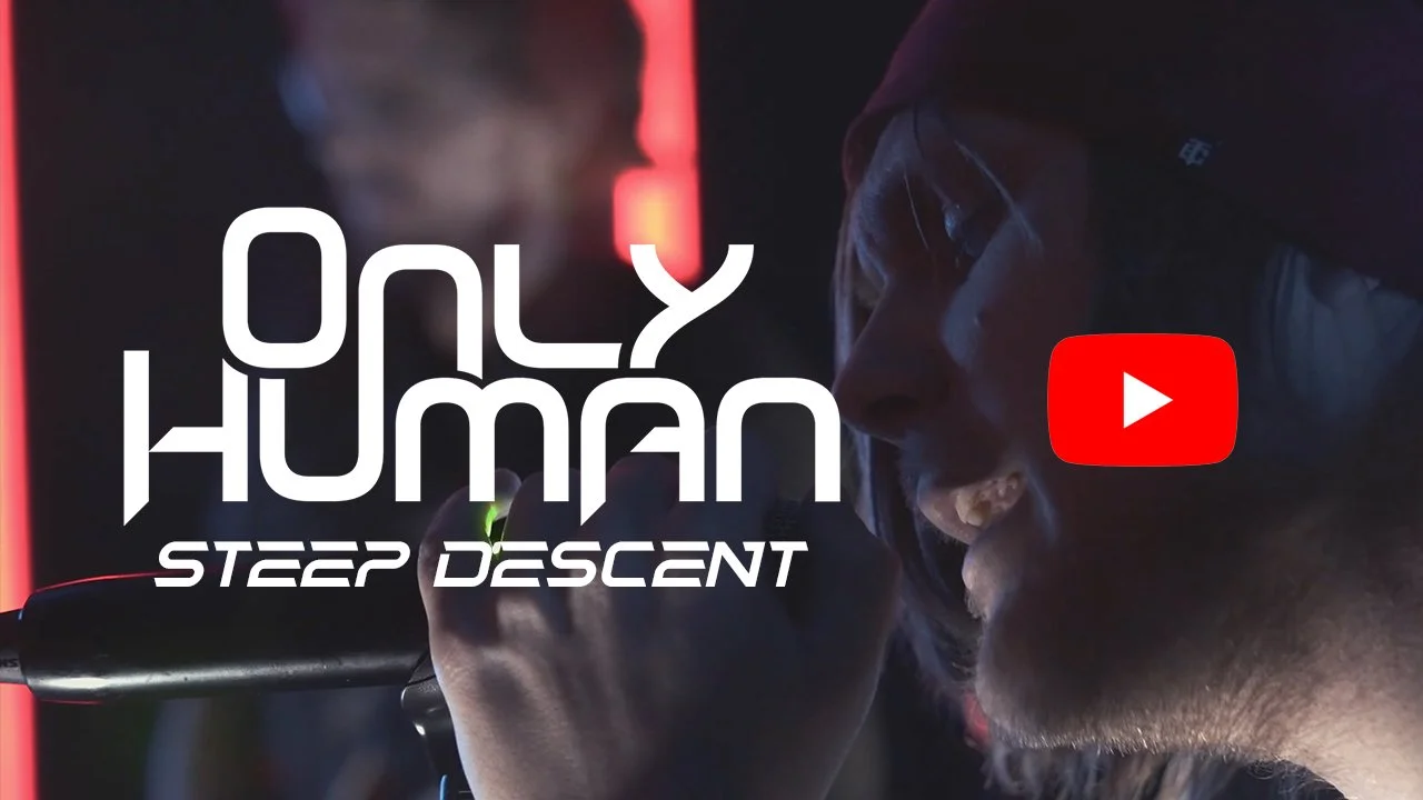 Thumbnail of a still from the play-through video of the song "Steep Descent". ONLY HUMAN frontman Patrick Christensen, holding a microphone close to his mouth, with text overlay saying 'Only Human Steep Descent' and a YouTube play button icon.