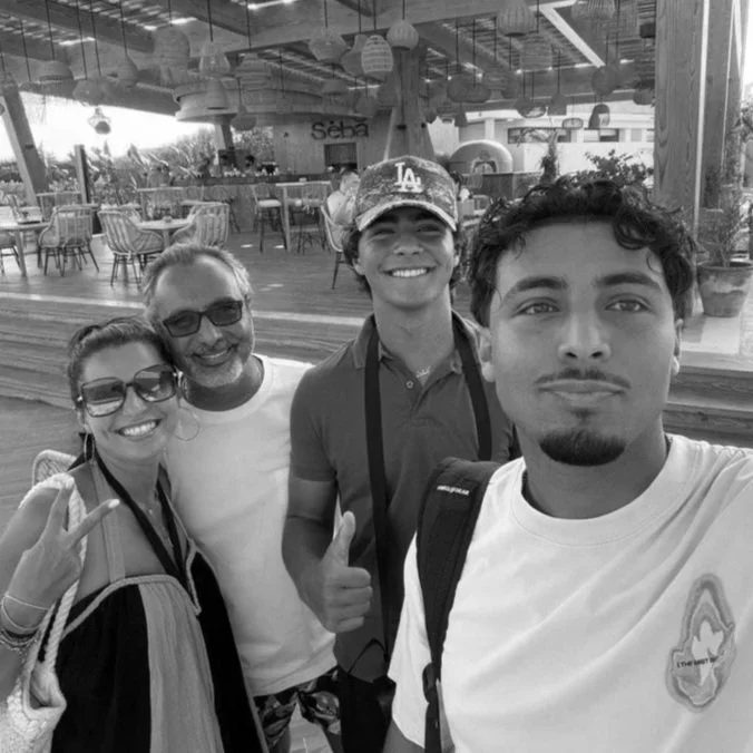 Black-and-white family selfie of Lydia Alfred with her family during an outdoor gathering.