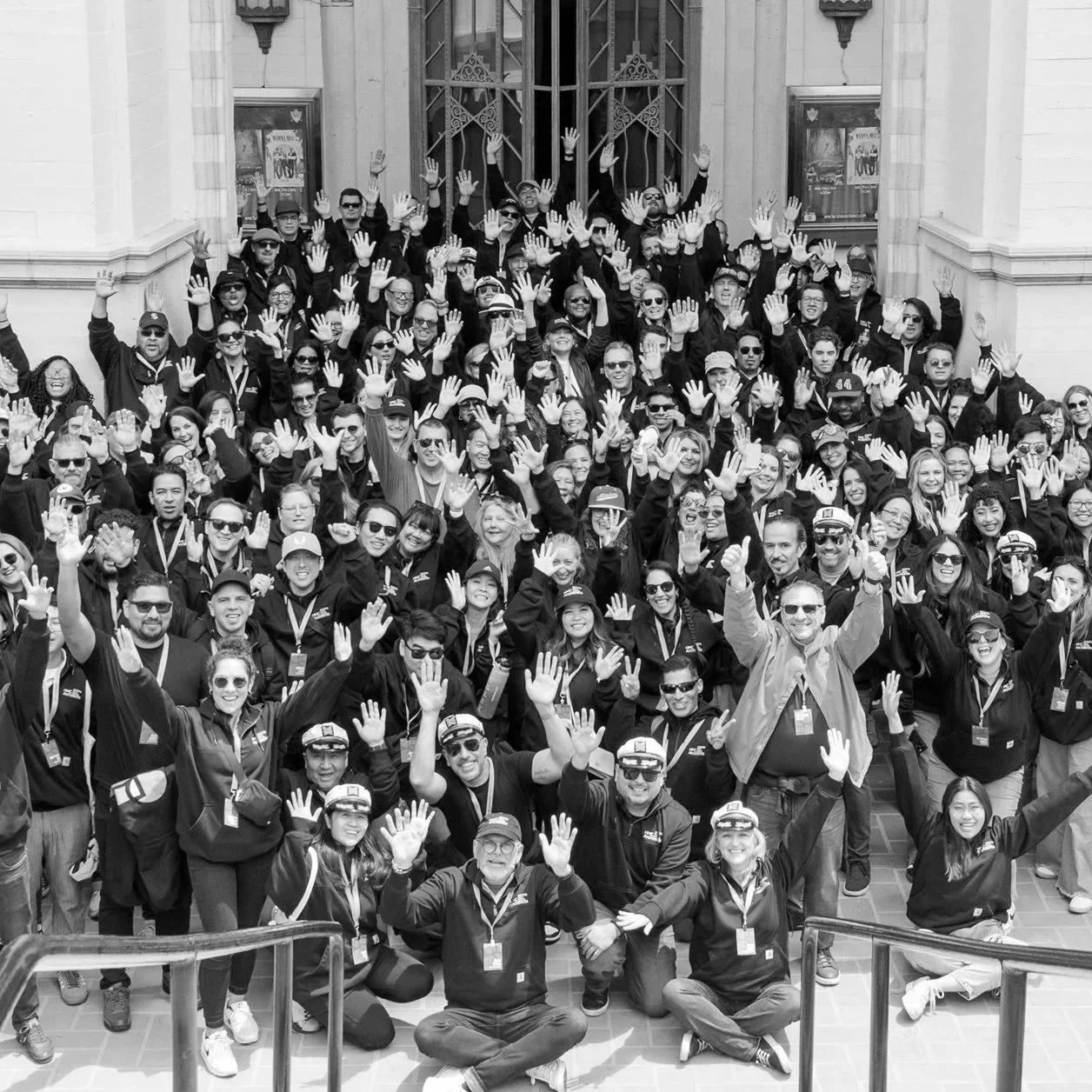Black-and-white group photograph of the HMC Architects team gathered together in a celebration for the firm.