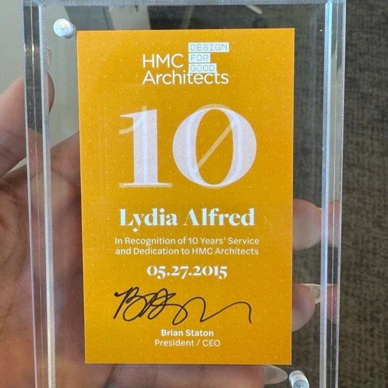 Ten-year service recognition award presented to Lydia Alfred by HMC Architects.