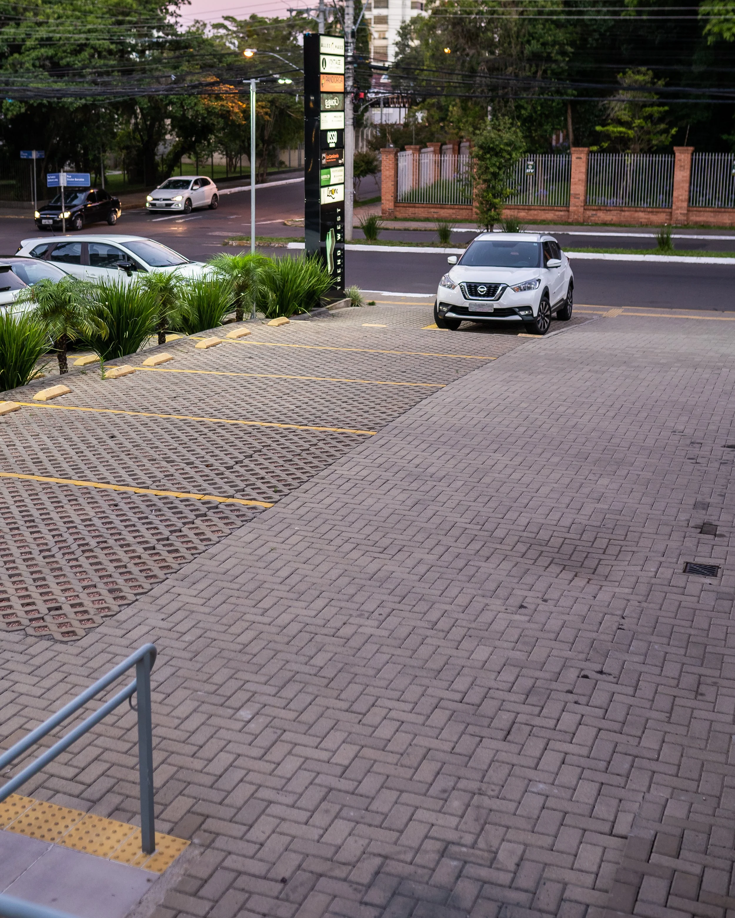 Estacionamento em frente ao Osso Parrilla Bar em Canoas, com totem das lojas