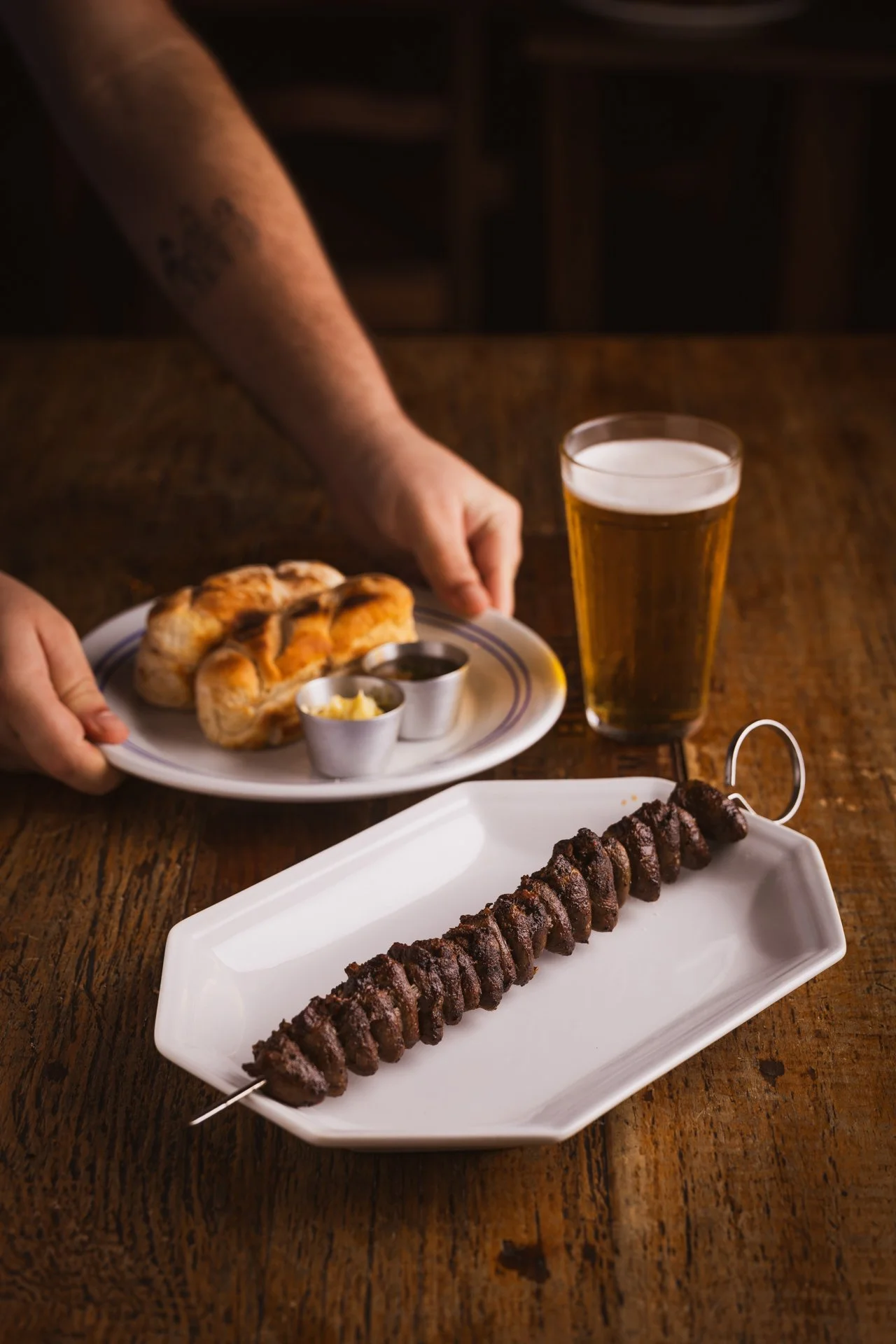 Espetinho de coraçãozinho com pão quentinho, molhos e copo de chopp