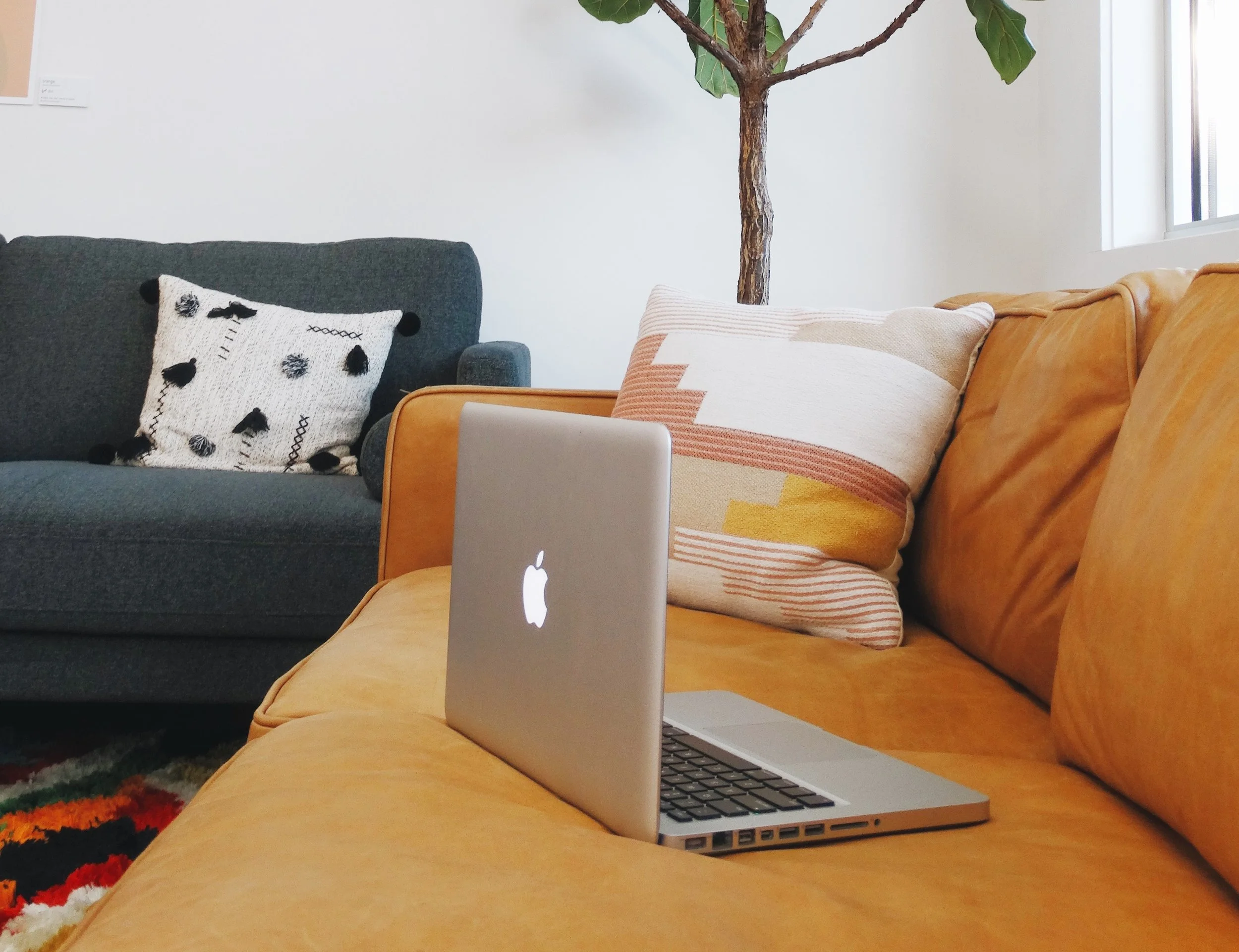 Laptop open on couch waiting for virtual therapy