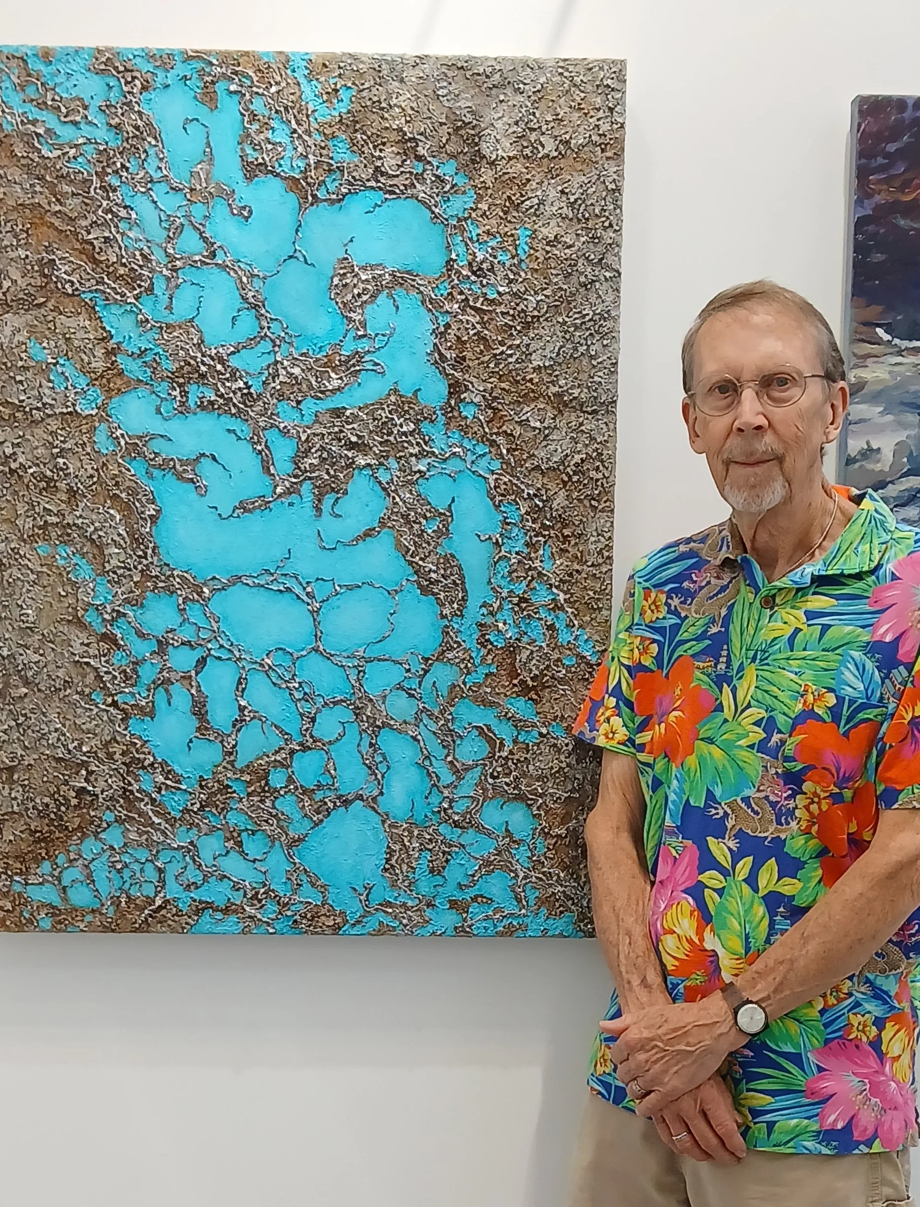 Artist Robert Gibbs standing beside his Turquoise textured art abstract painting.