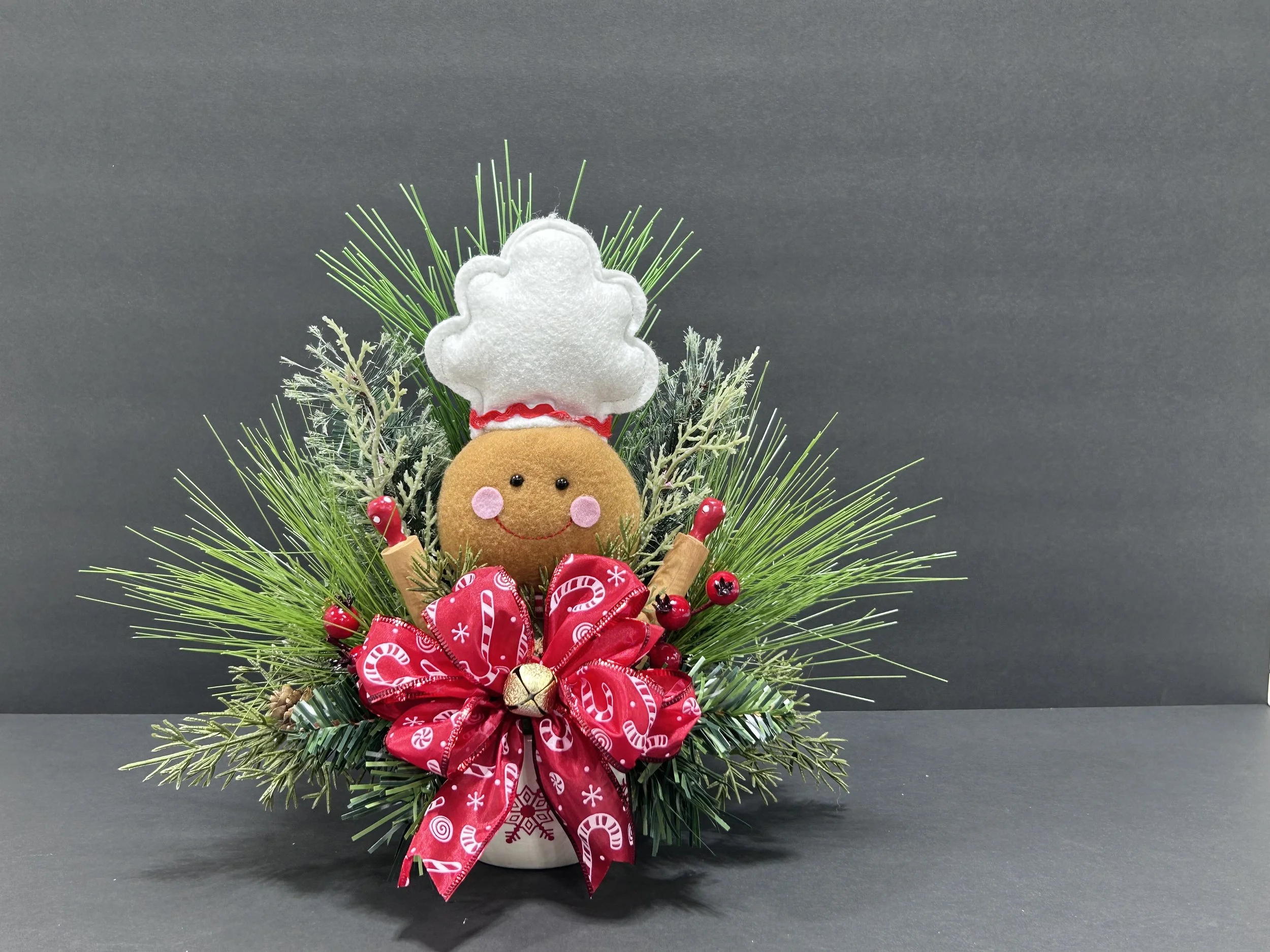 Medium handmade Gingerbread Chef Christmas centerpiece, approximately 11 inches tall, featuring festive greenery, red berries, Christmas ribbon, and a decorative holiday bowl.