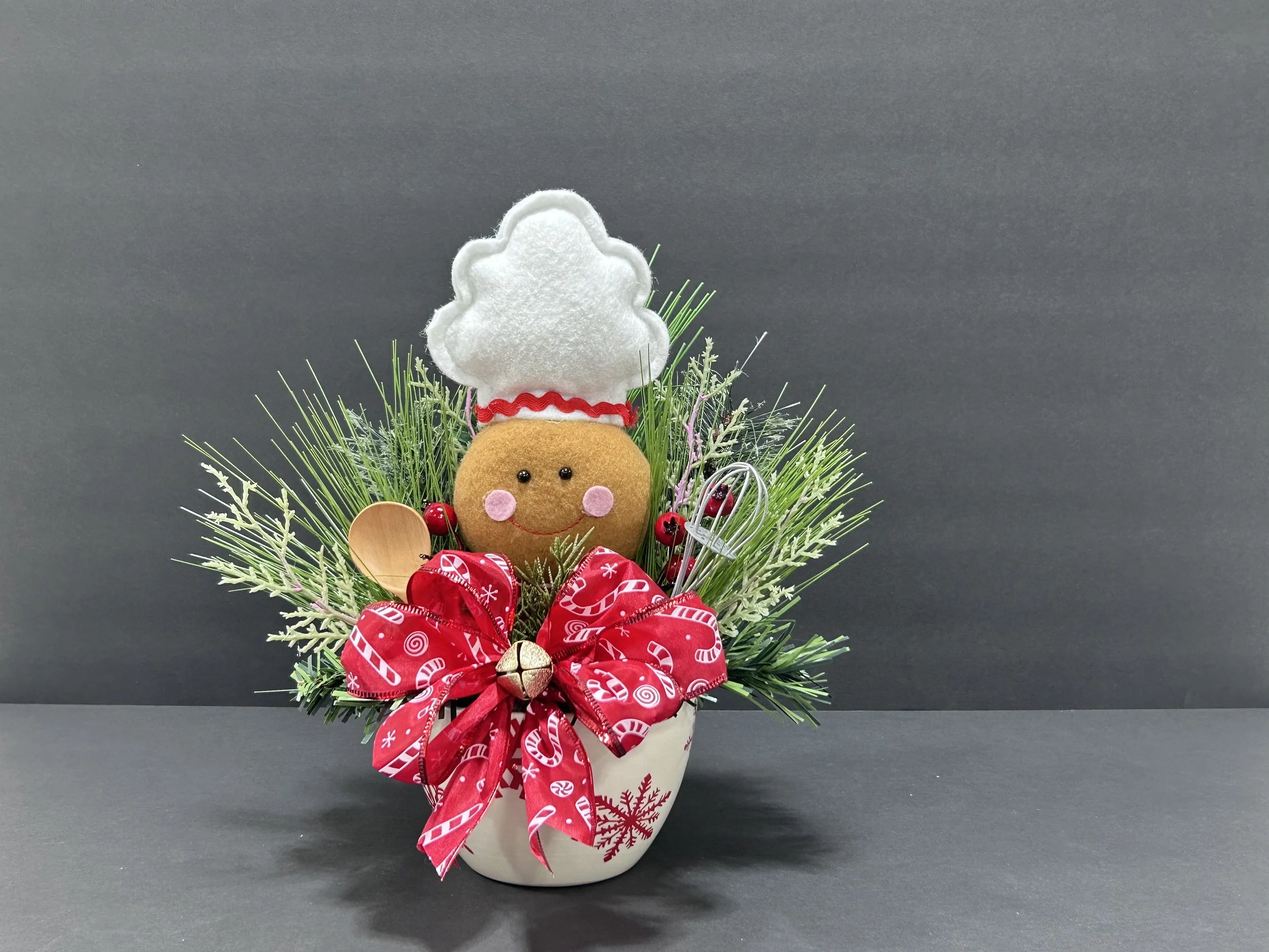 Medium handmade Gingerbread Chef Christmas centerpiece, approximately 11 inches tall, featuring festive greenery, red berries, Christmas ribbon, and a decorative holiday bowl.