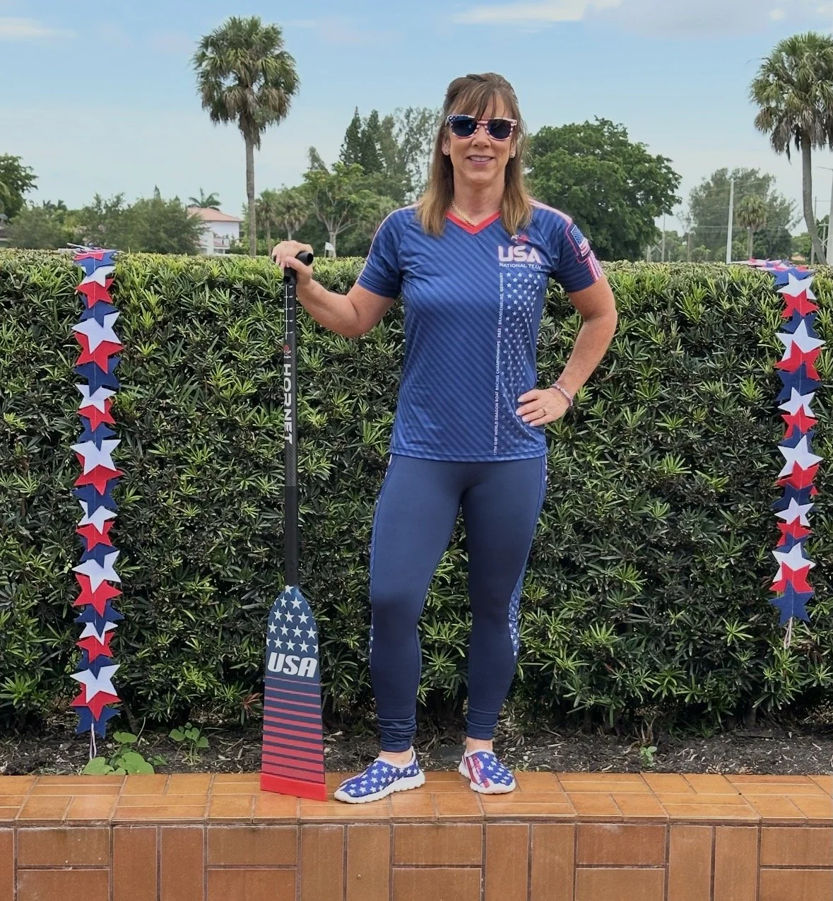 Educator and Team USA breast cancer survivor dragon boat athlete in uniform.