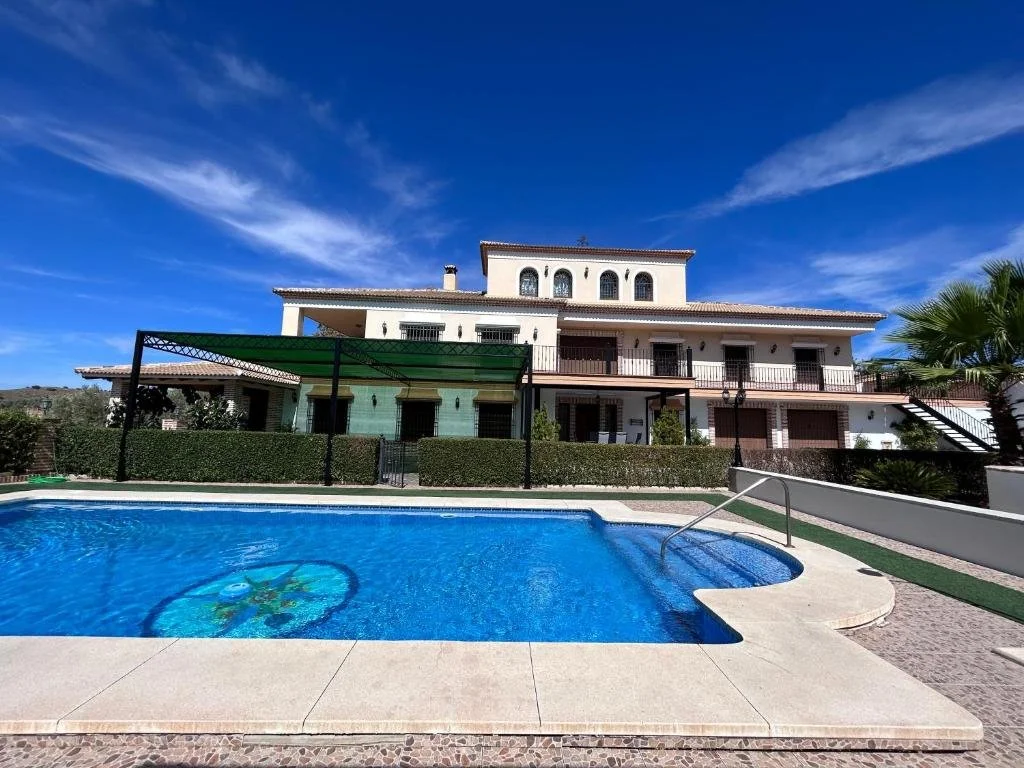 Panoramic view of the exclusive white Andalusian luxury villa and private outdoor swimming pool courtyard at the Valere Spain wellness retreat.