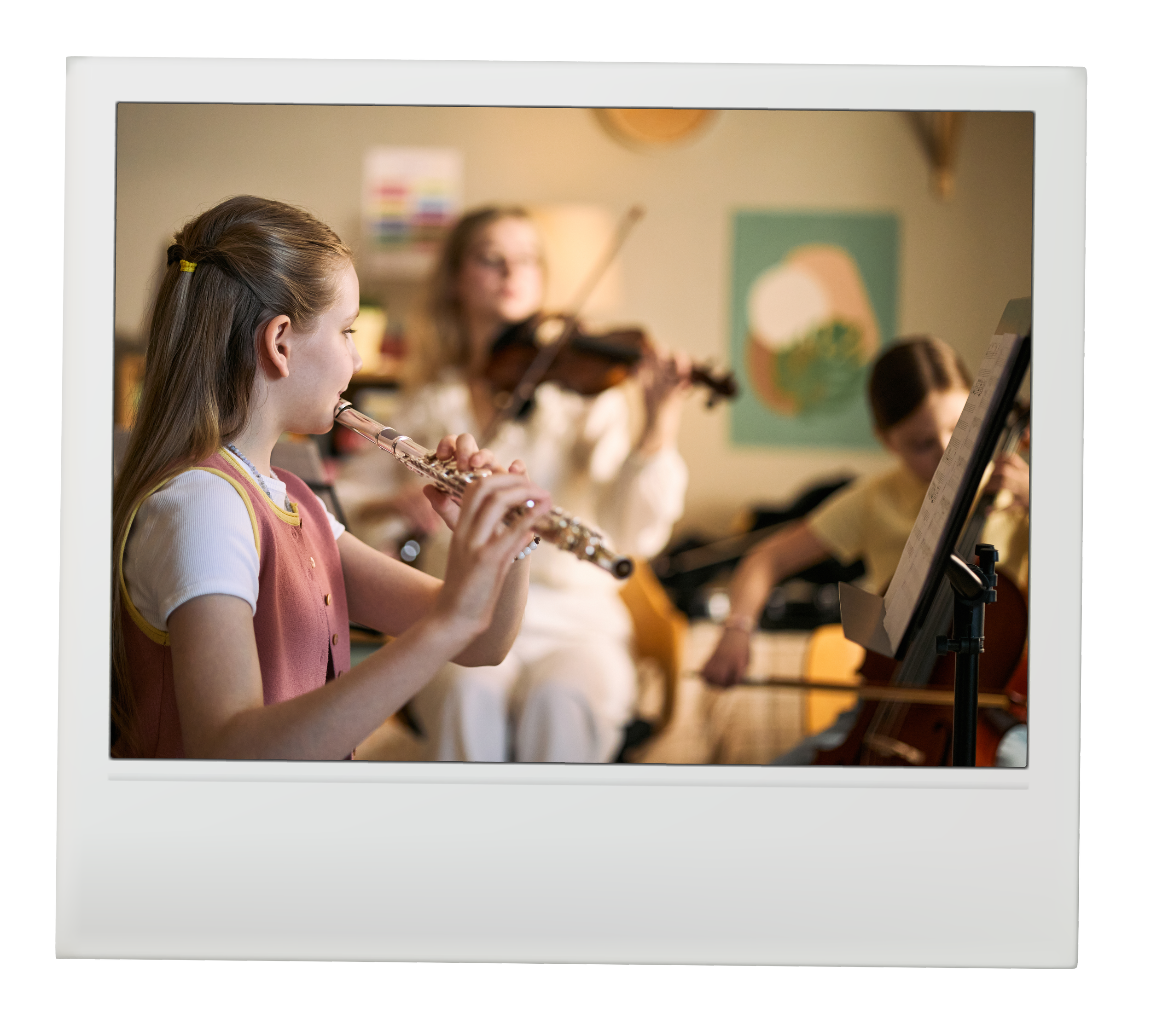 Children playing musical instruments in a classroom with music stand and colorful artwork on the wall.