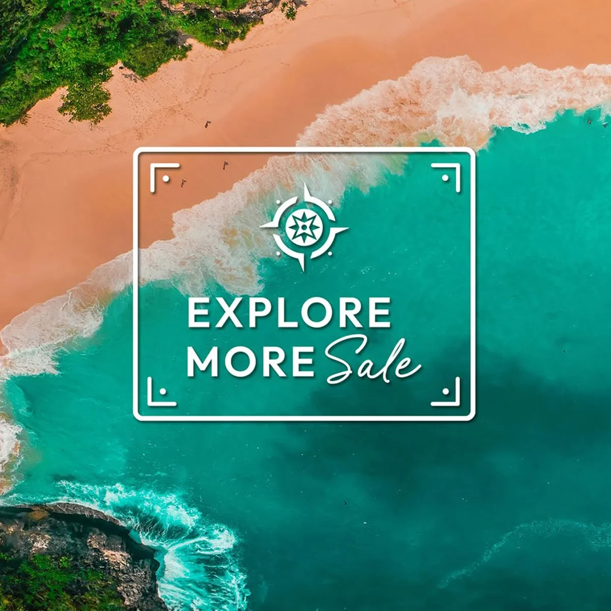 Aerial view of a beach with turquoise ocean waves hitting a sandy shore covered with greenery. Overlaid text says 'Explore More Sale' within a frame with a compass icon.