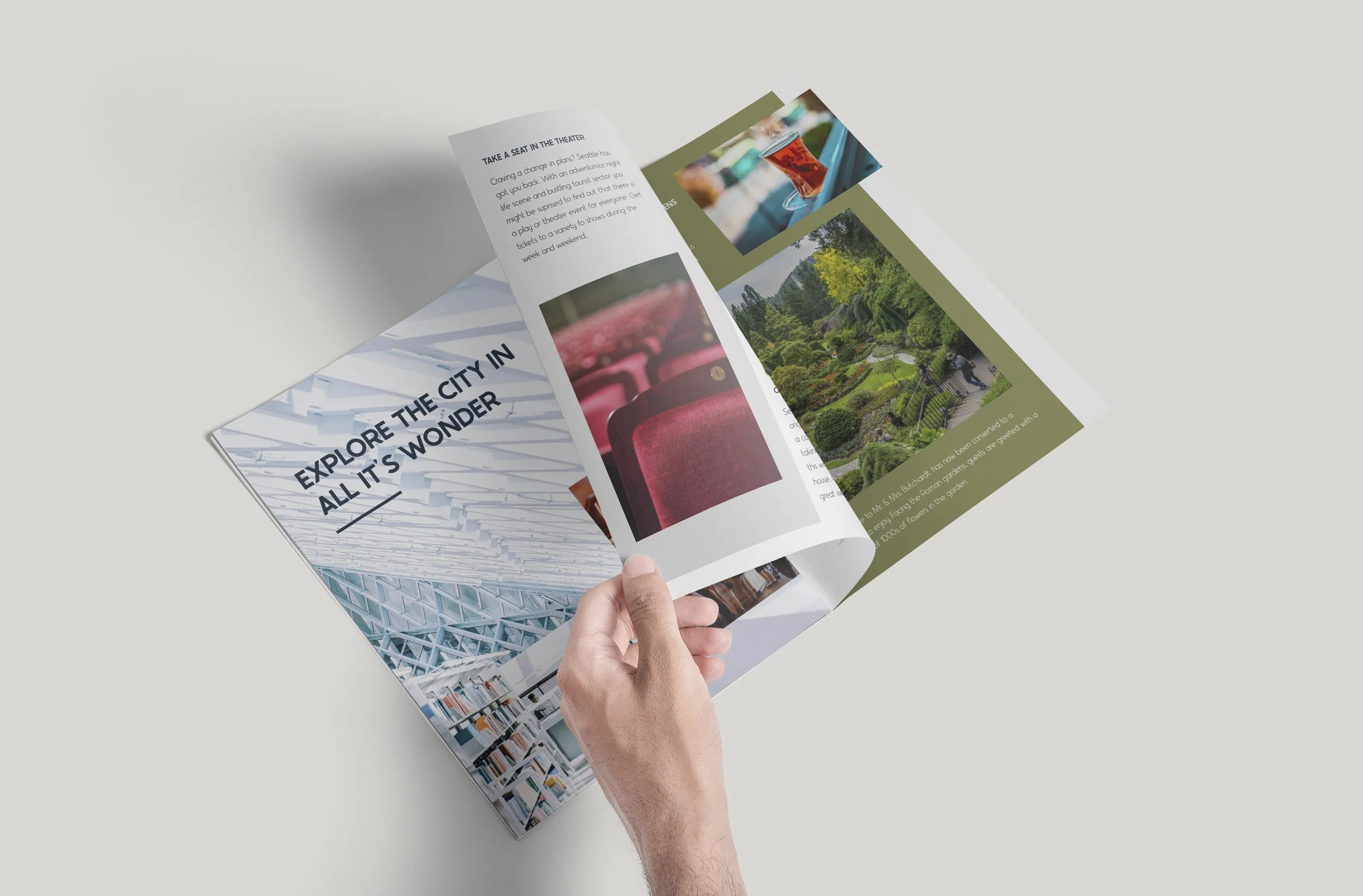 A person holding a folded brochure or magazine with colorful images and text, including a garden scene and a drink with a glass of tea.