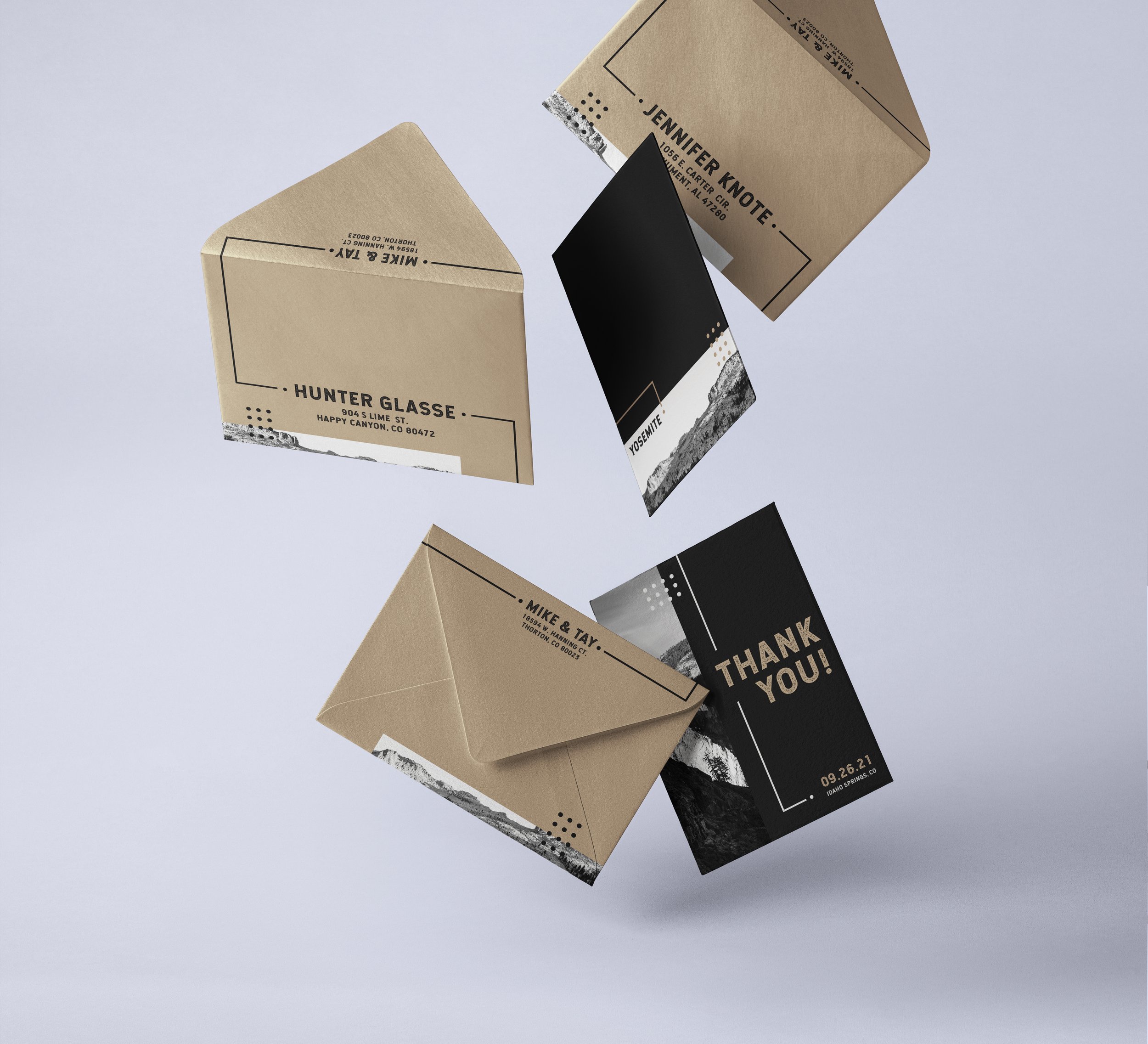 Multiple business cards with black and beige designs, featuring names and addresses, arranged on a light background.