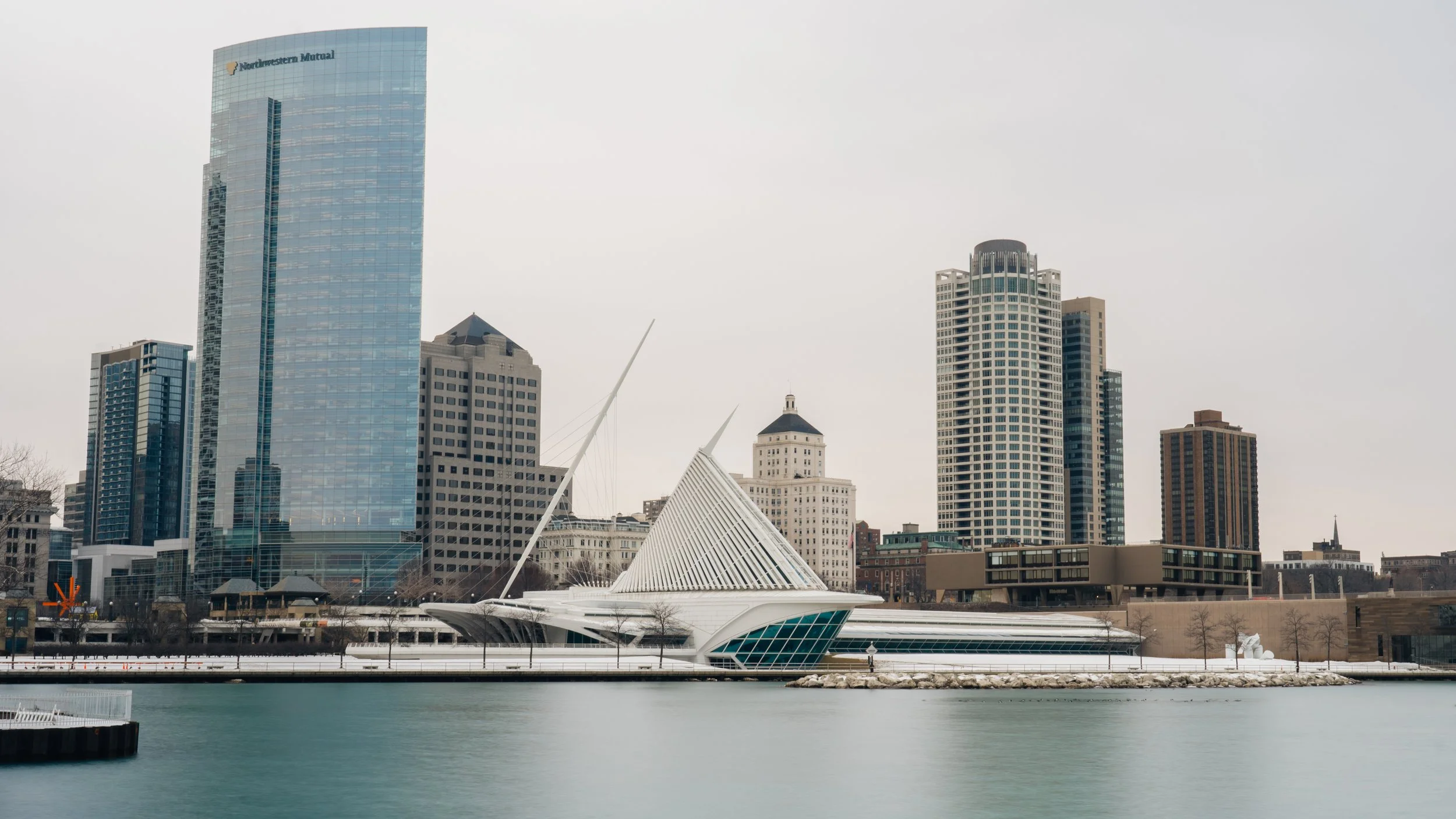 View of a city skyline with modern skyscrapers and a waterfront, with the Cleveland Museum of Art's White Castle in the foreground.