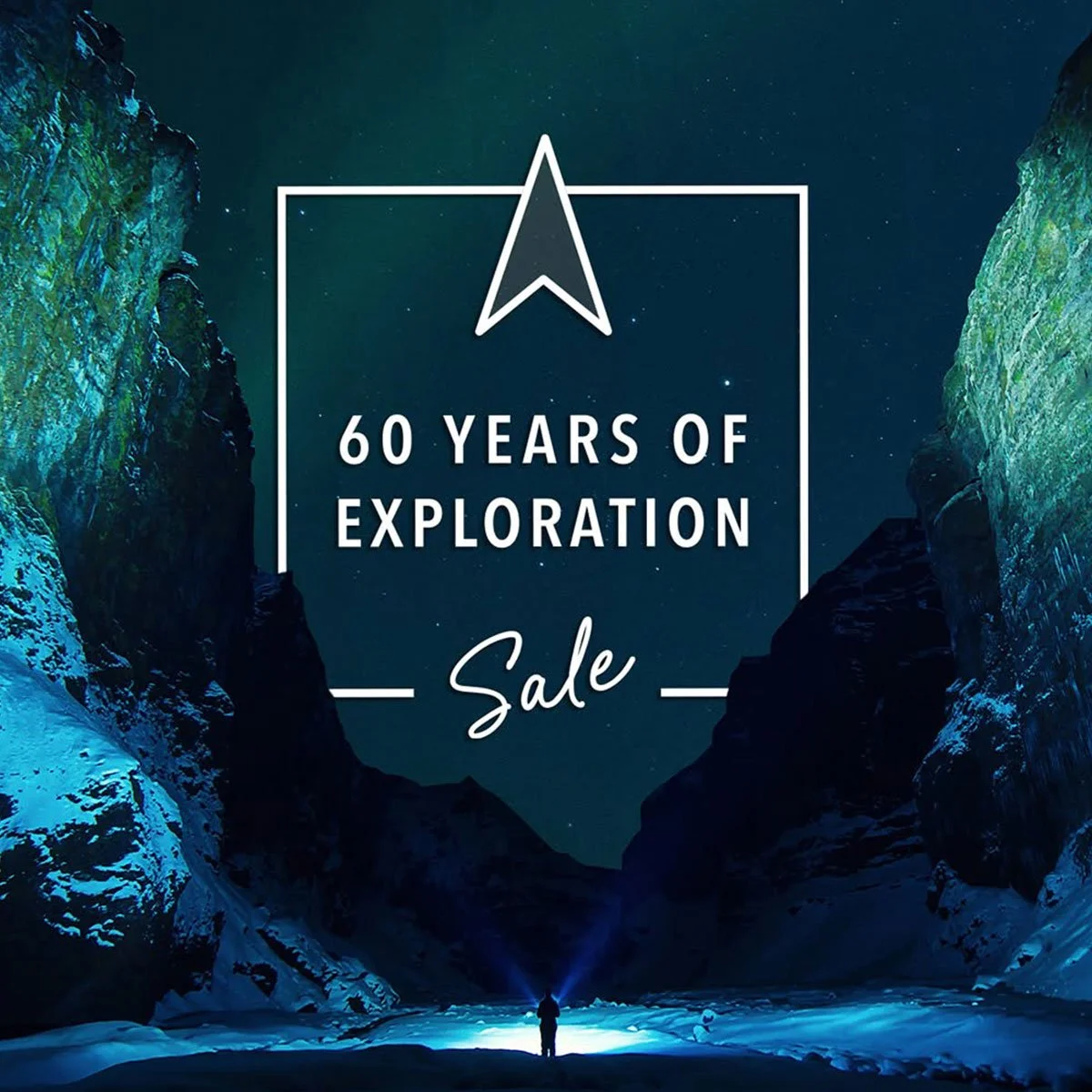 Nighttime scene of a person with a flashlight between snow-covered mountains with a starry sky, celebrating 60 years of exploration sale.