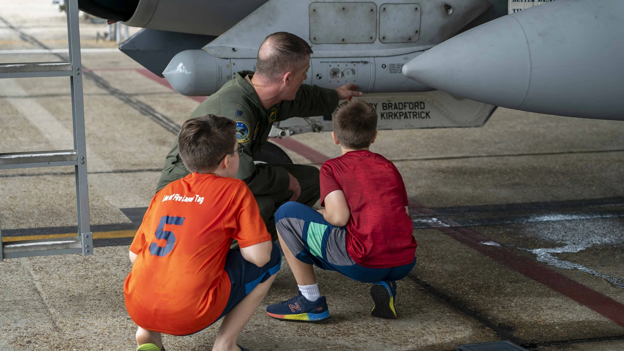 Mike “Hondo” Fiandt, owner of Hondo’s Wood Co, explaining some equipment on an F-16 fighter jet to his boys. Hondo is a proud Air Force veteran, engineer, and wood worker.