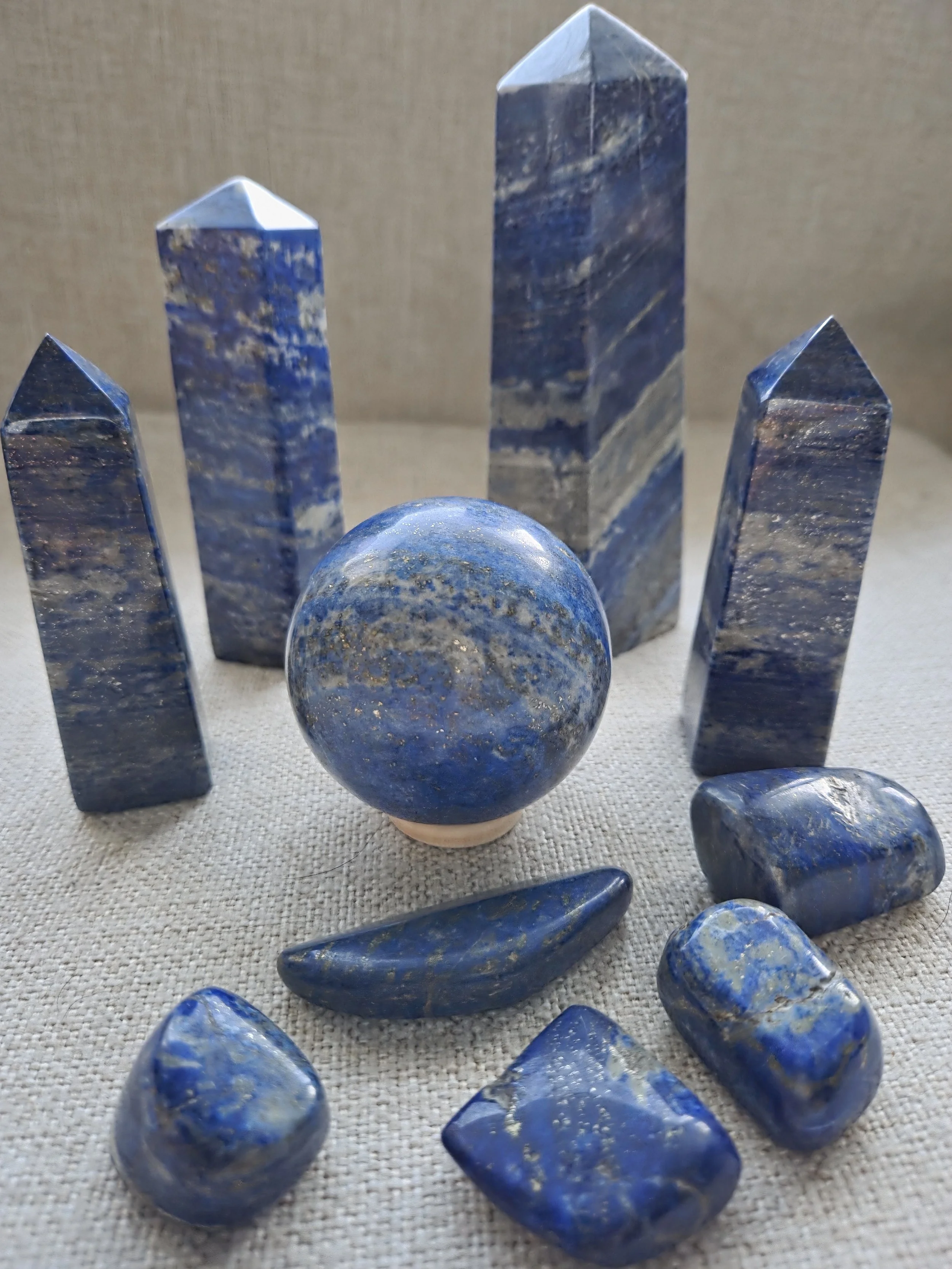 Lapis lazuli crystal towers, sphere, and polished tumble stones
